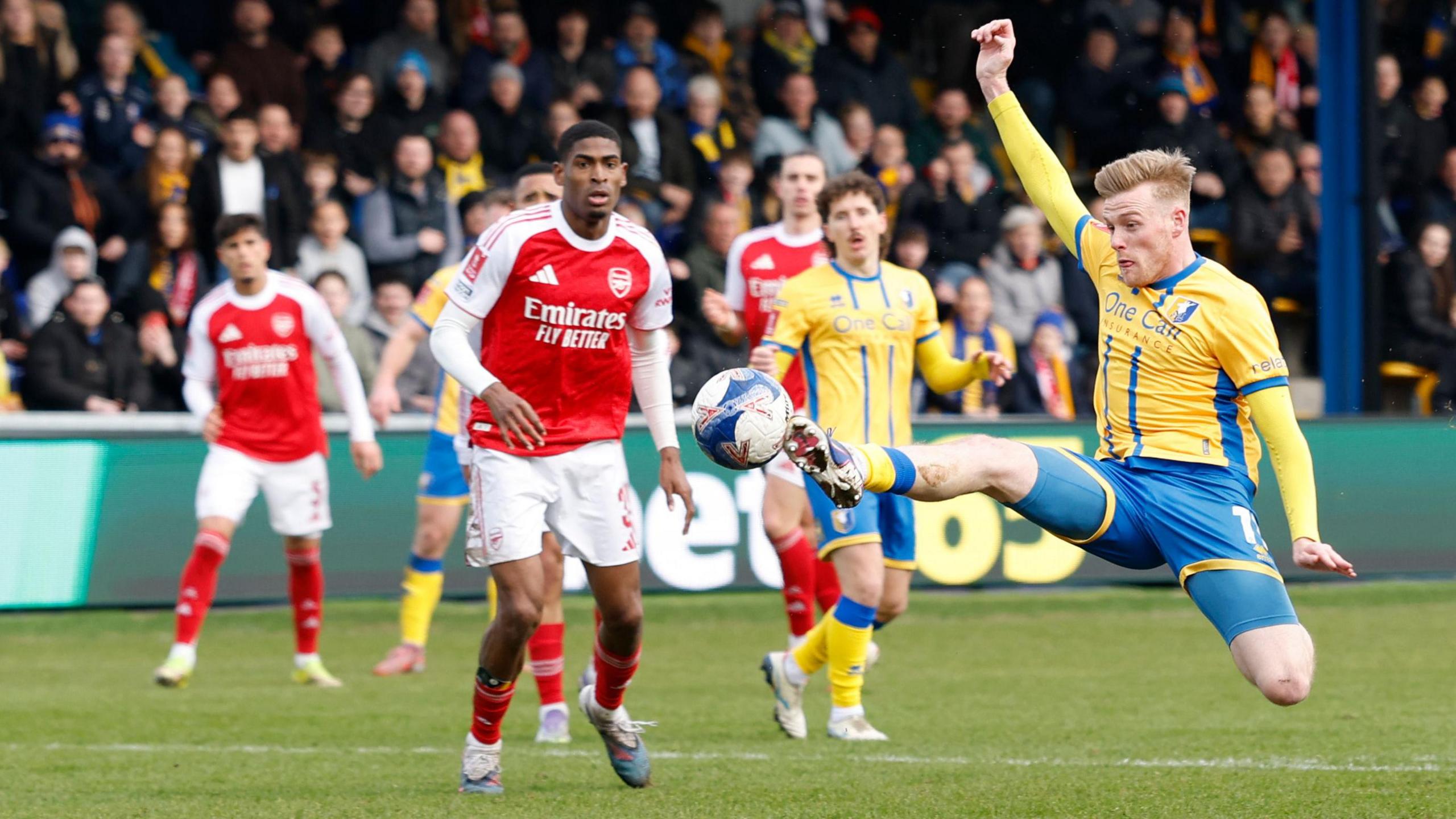 Mansfield Town's Will Evans tries to connect with a cross during the Emirates FA Cup fifth round match against Arsenal at One Call Stadium