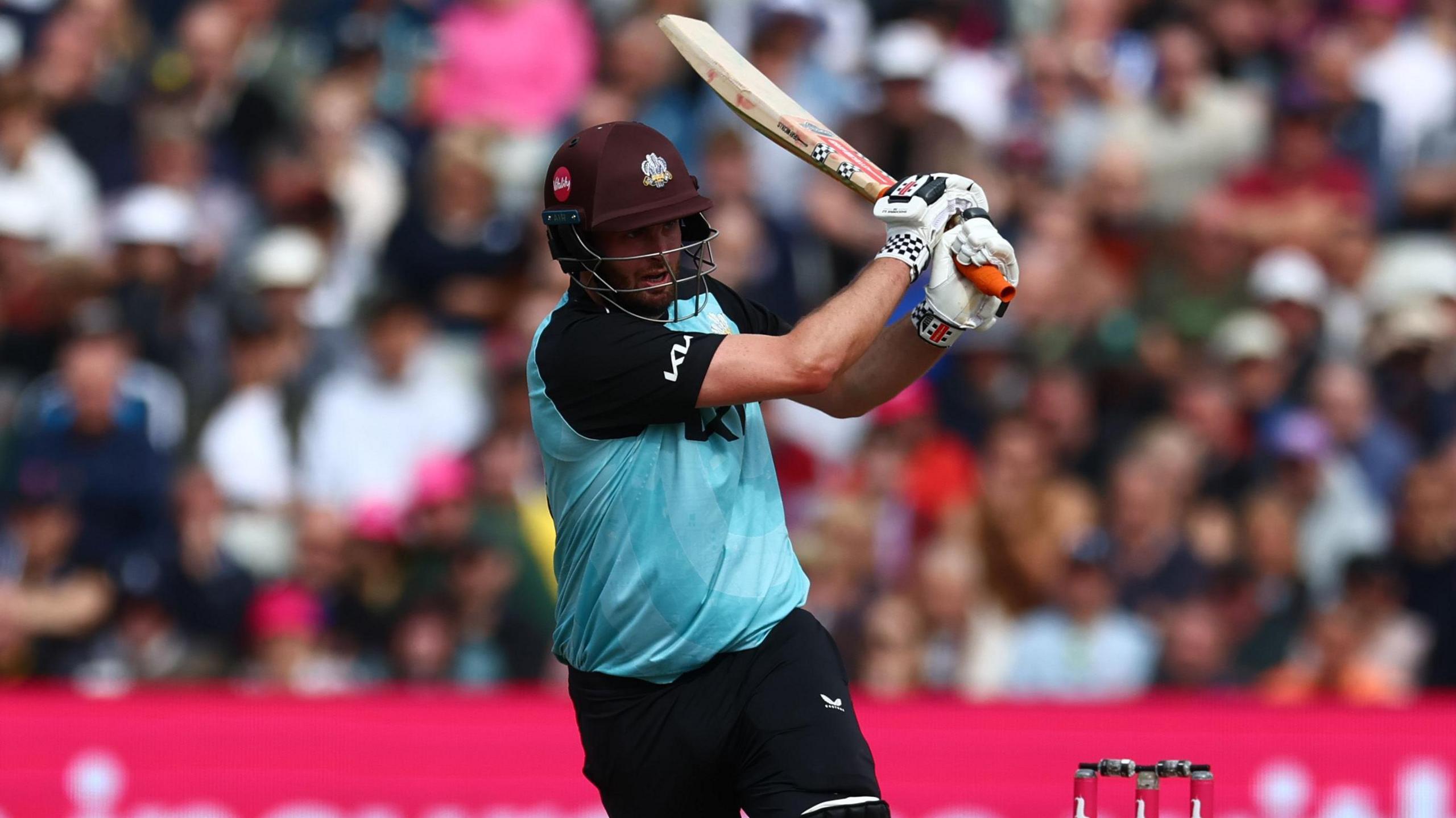 Surrey's Dom Sibley swats a legside boundary back on his old ground at Edgbaston 