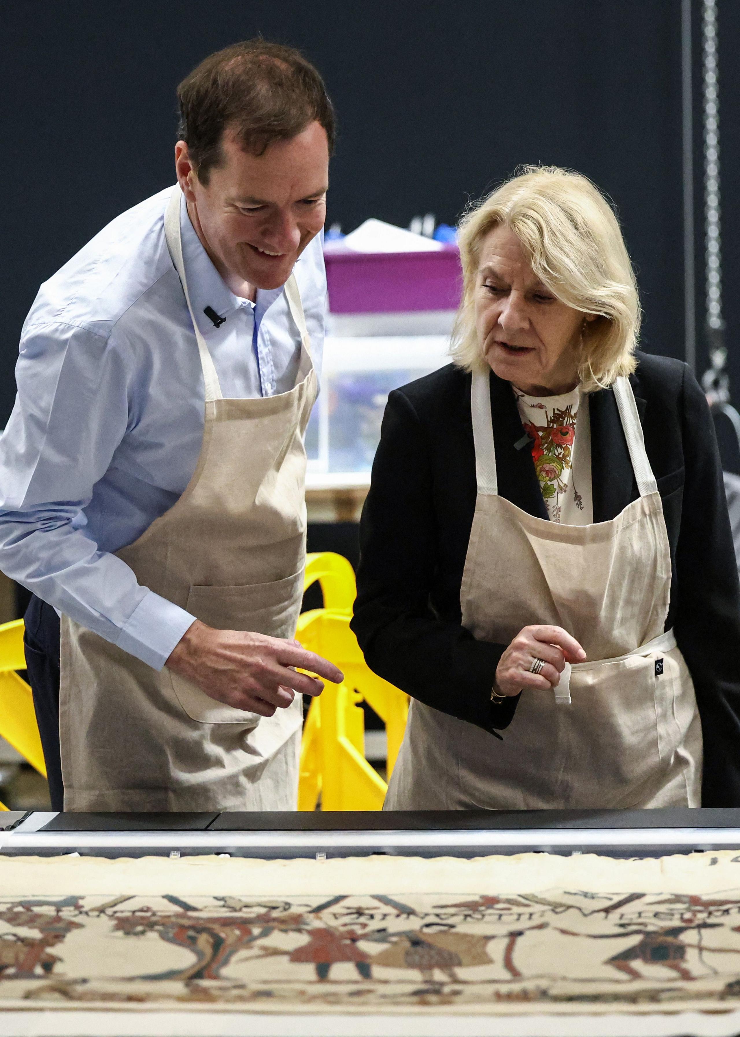 British Museum chair, George Osborne  looking at a section of the Bayeux Tapestry, along with the French Culture Minister, Catherine Pégard 
Tapestry is laid out on the table