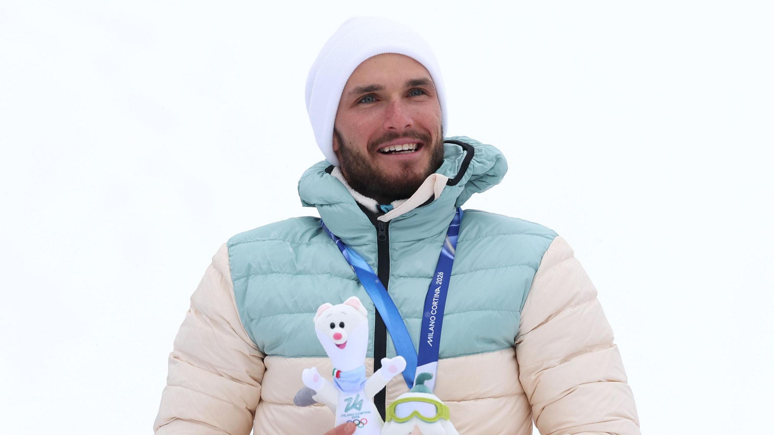 Nikita Filippov, from Russia, celebrates winning an Olympic 'skimo' medal as an Individual Neutral Athlete