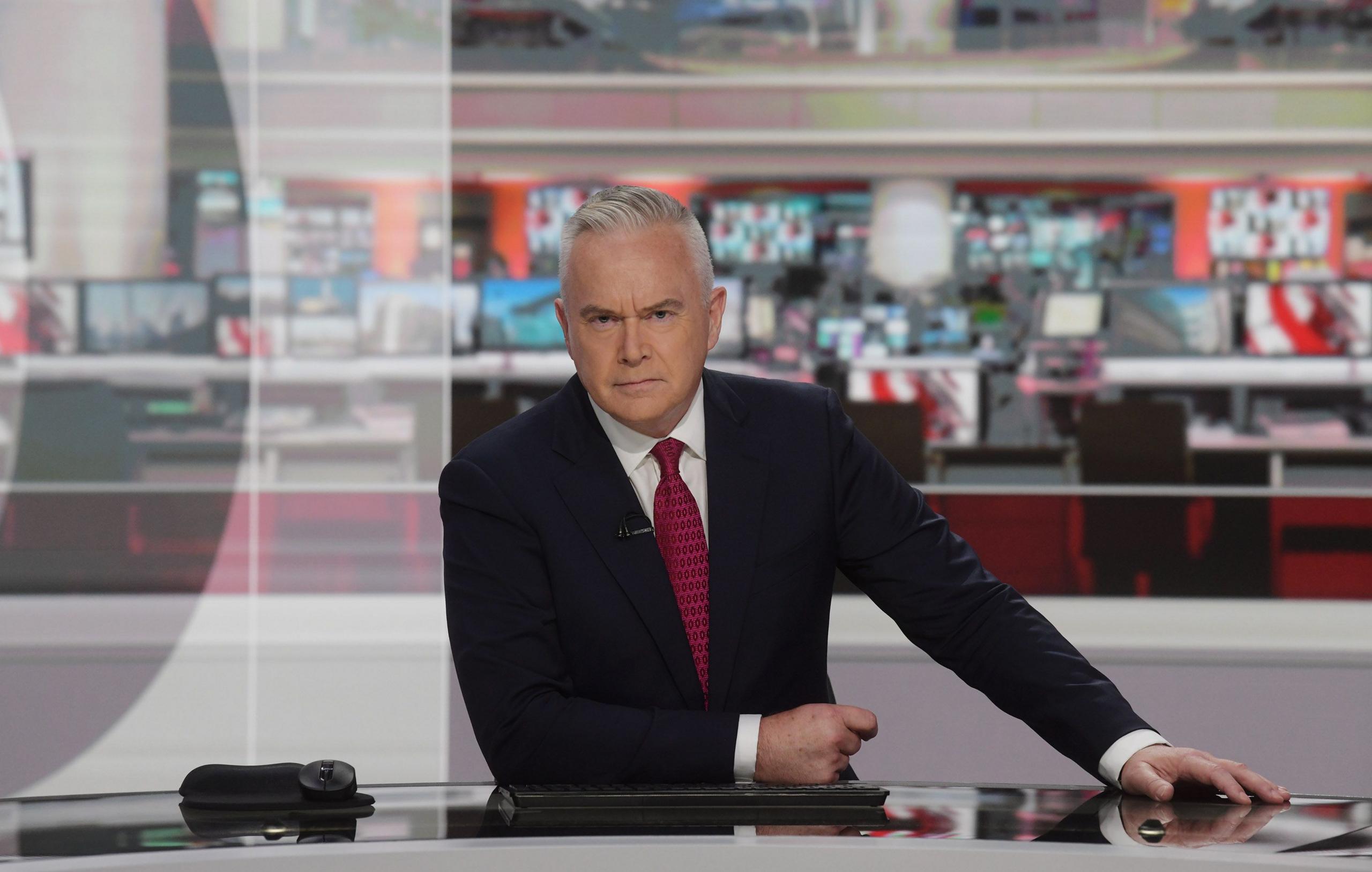 Huw Edwards reading the news