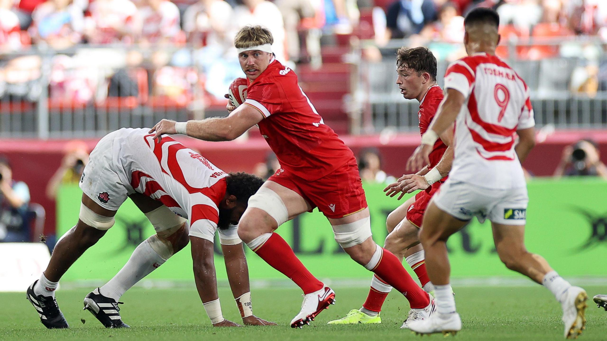 Aaron Wainwright on the charge for Wales against Japan