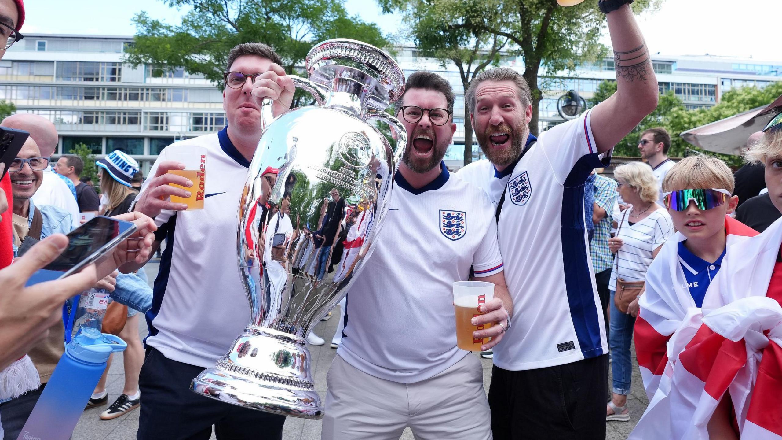 England fans hold up a replica Euro 2024 trophy