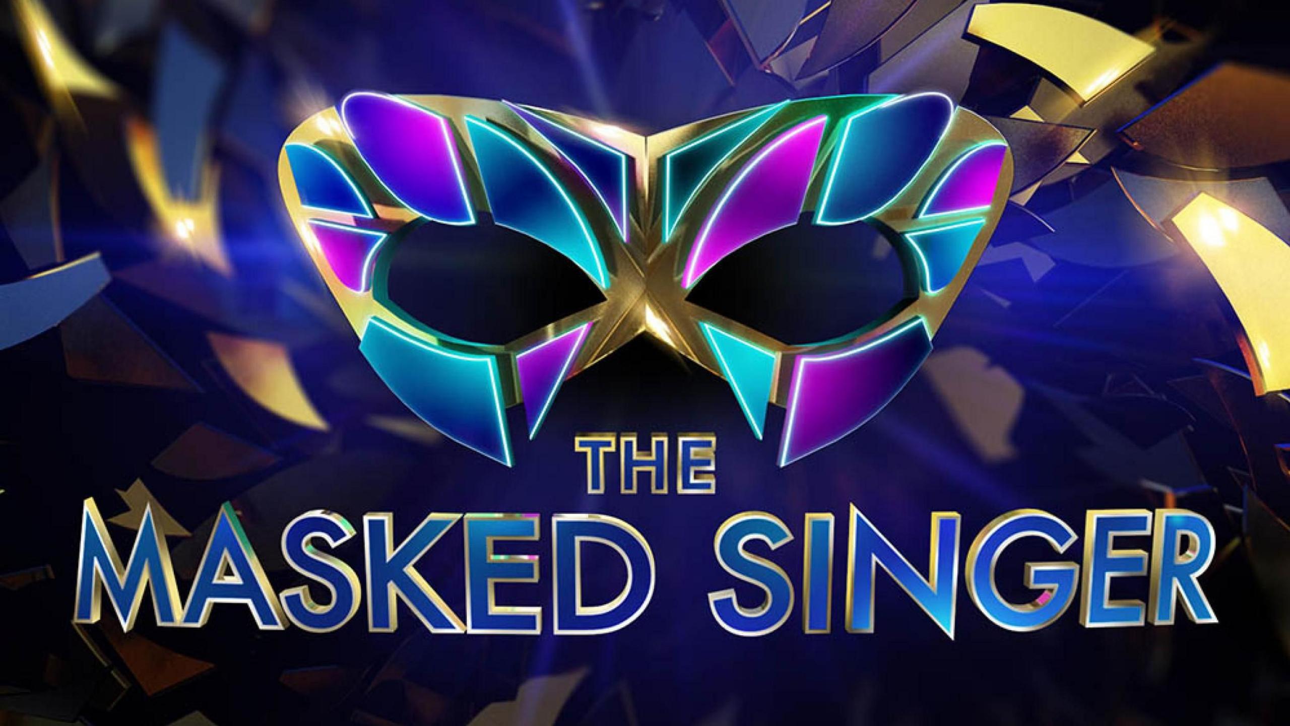 The logo of TV show The Masked Singer, featuring a mask made of blue and purple shapes.