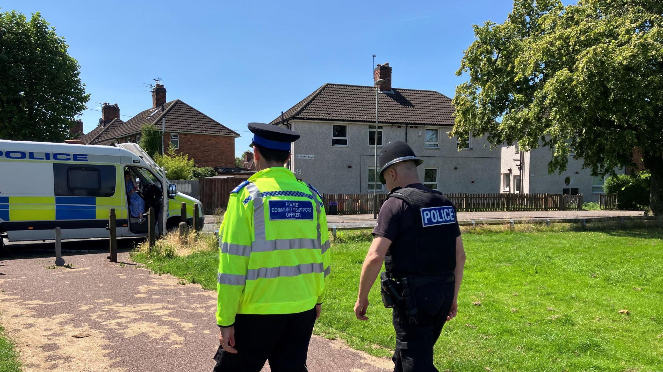 A Leicestershire PCSO and police officer, with their backs to camera