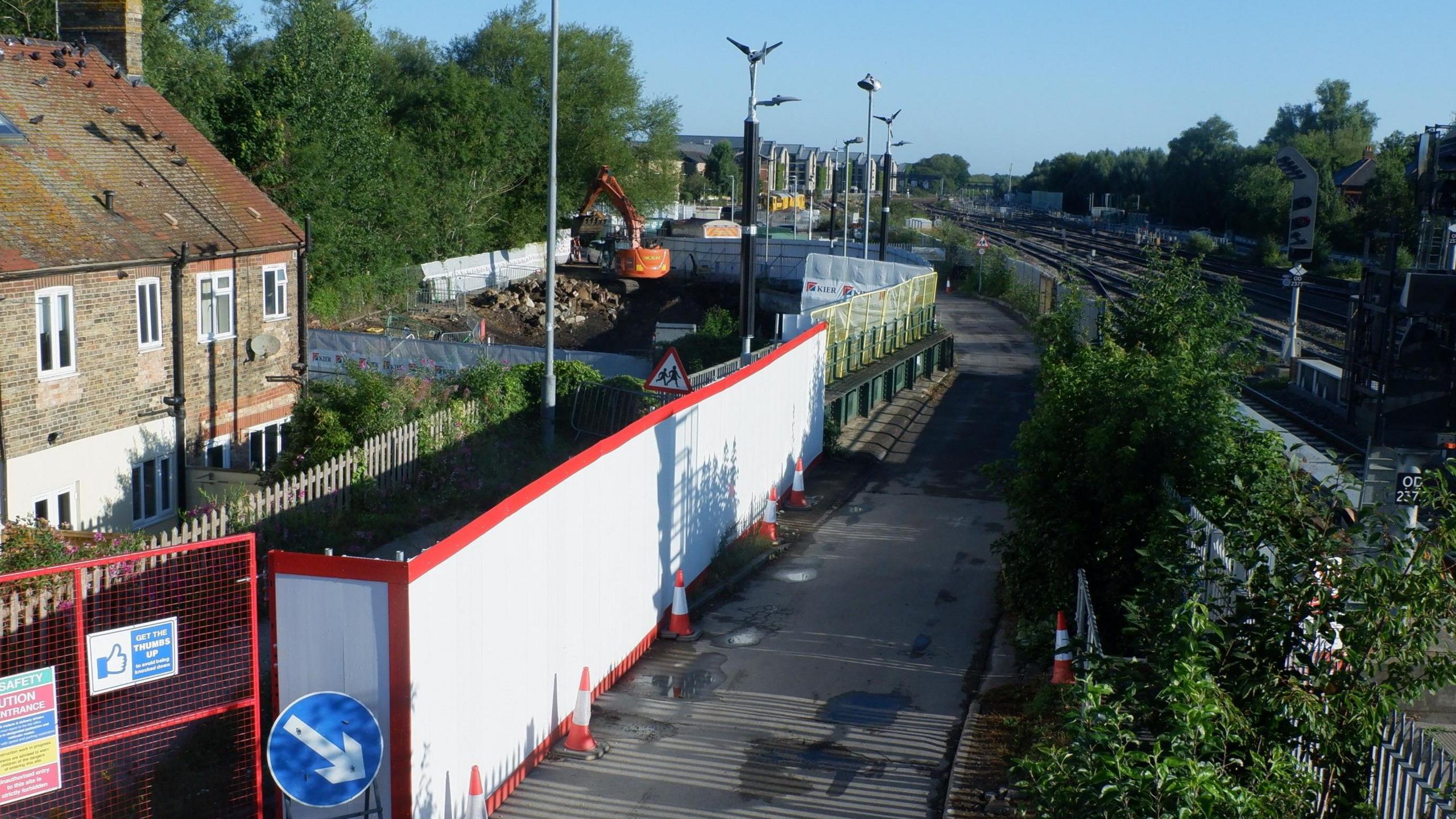 Works near the The Old Station Nursery site. It is shown surrounded with white and red dividers. photographed on a sunny day.