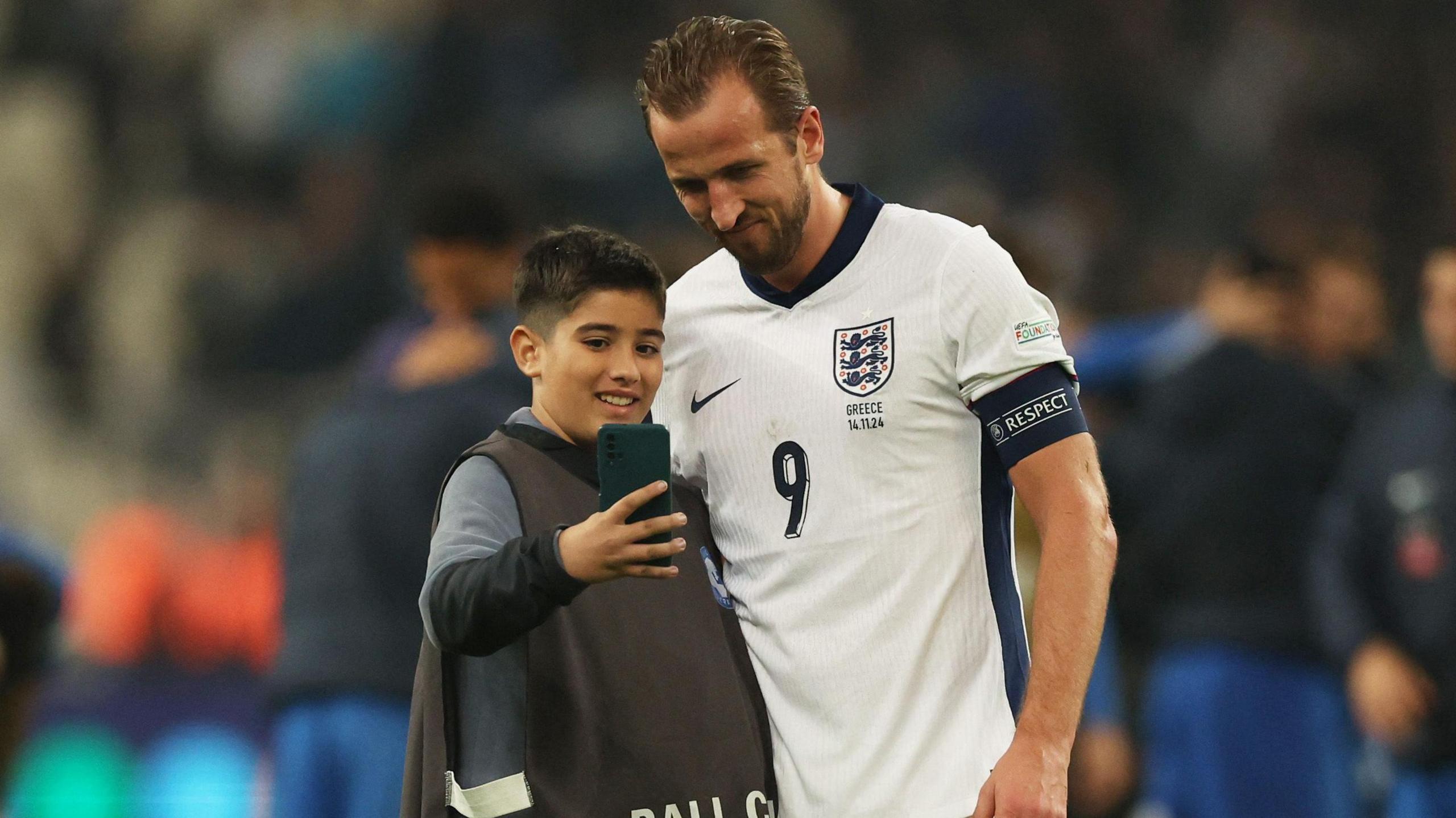 After the win, England captain Harry Kane stopped for a selfie with one of the ball kids at the Olympic Stadium in Athens, Greece. 