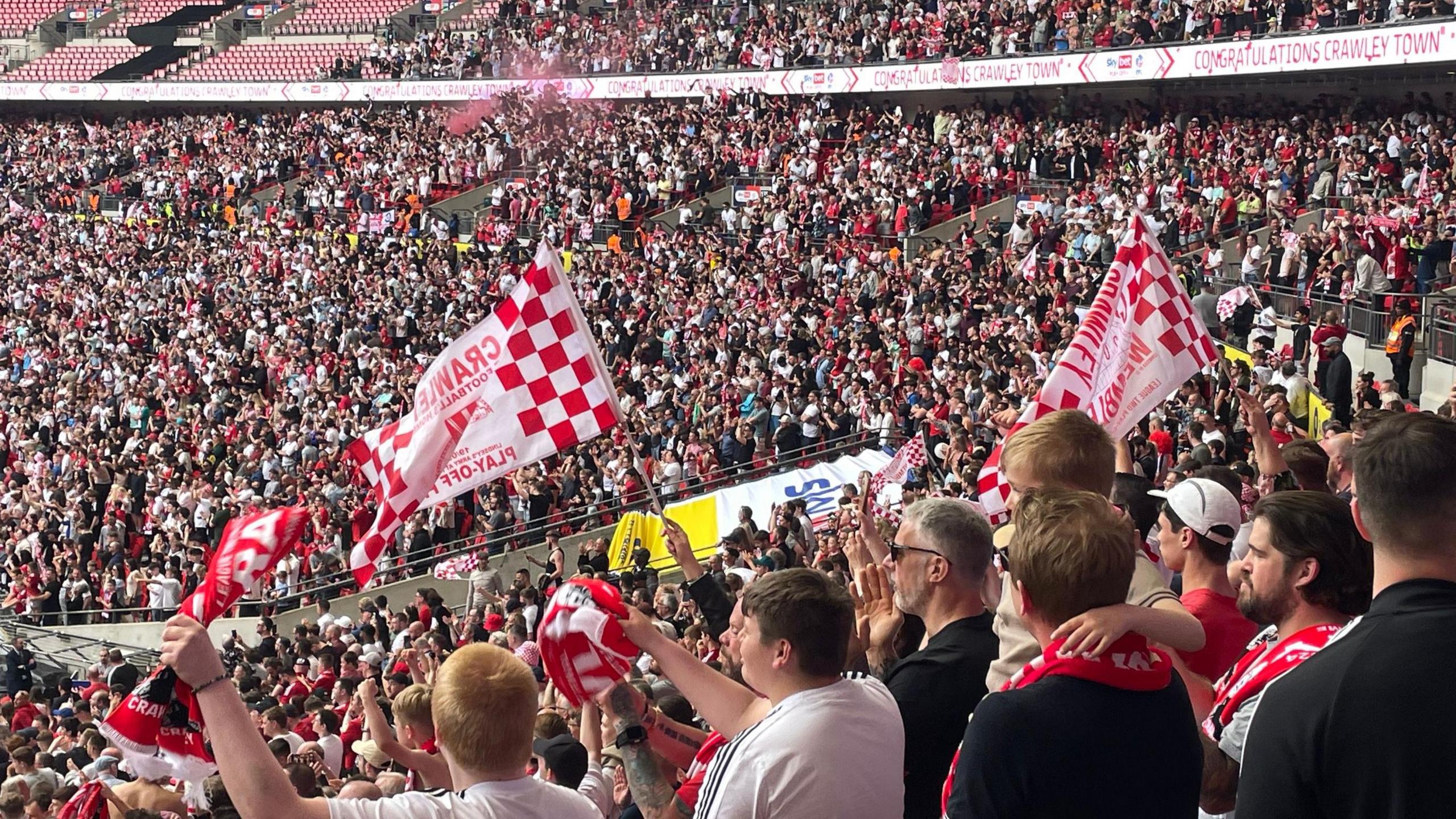 Thousands of Crawley fans celebrating in Wembley Stadium after the final whistle