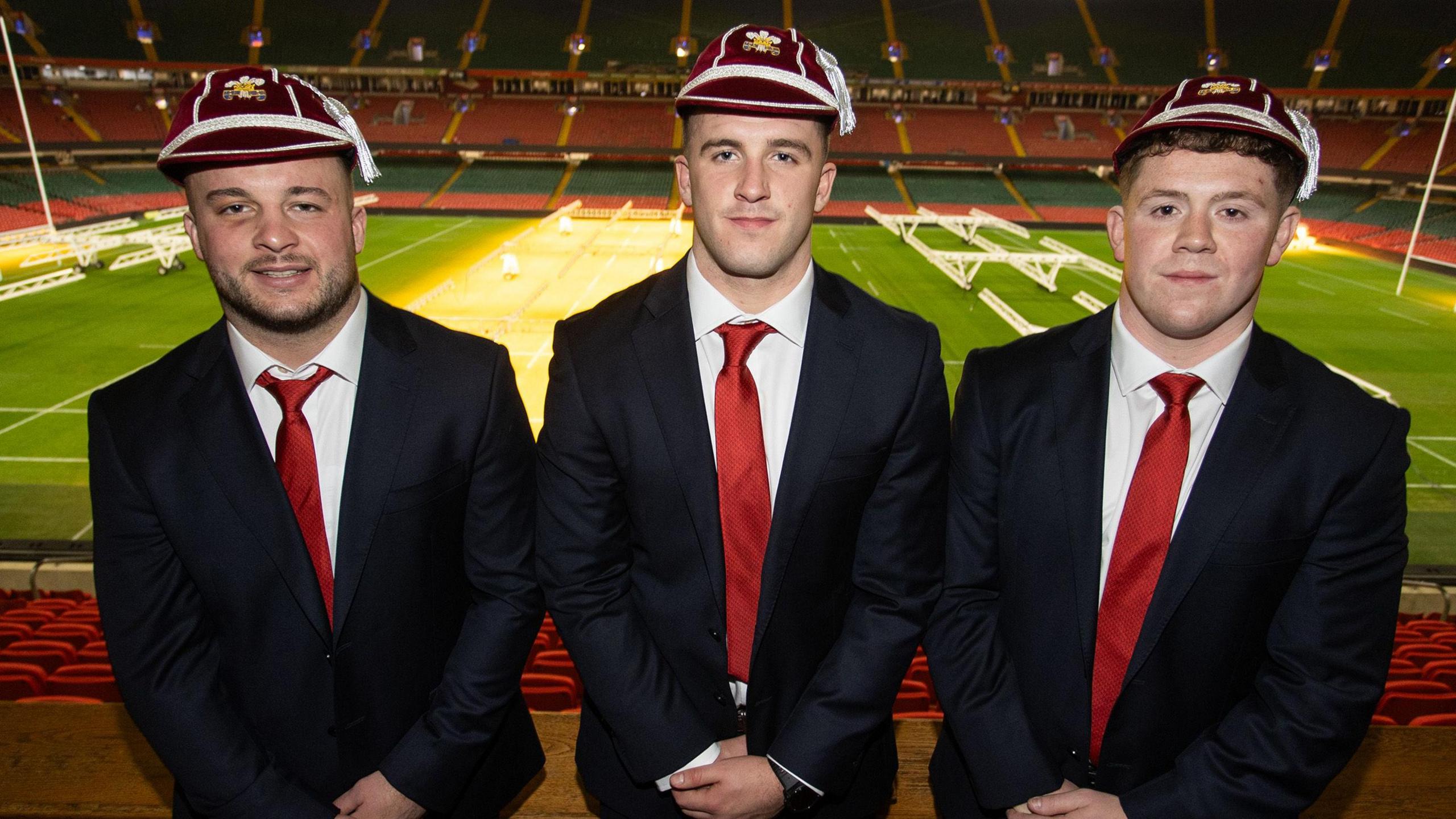 Harri Deaves, Morgan Morse and Brodie Coghlan wearing their Wales caps and suits at the Principality Stadium