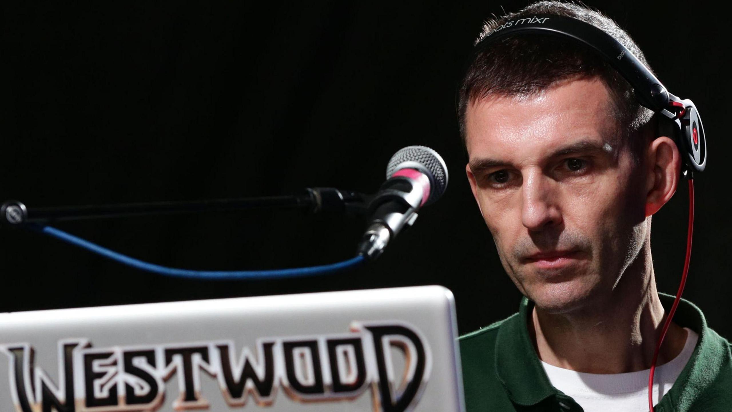 Tim Westwood pictured in 2014 DJing, using a laptop with his surname on it