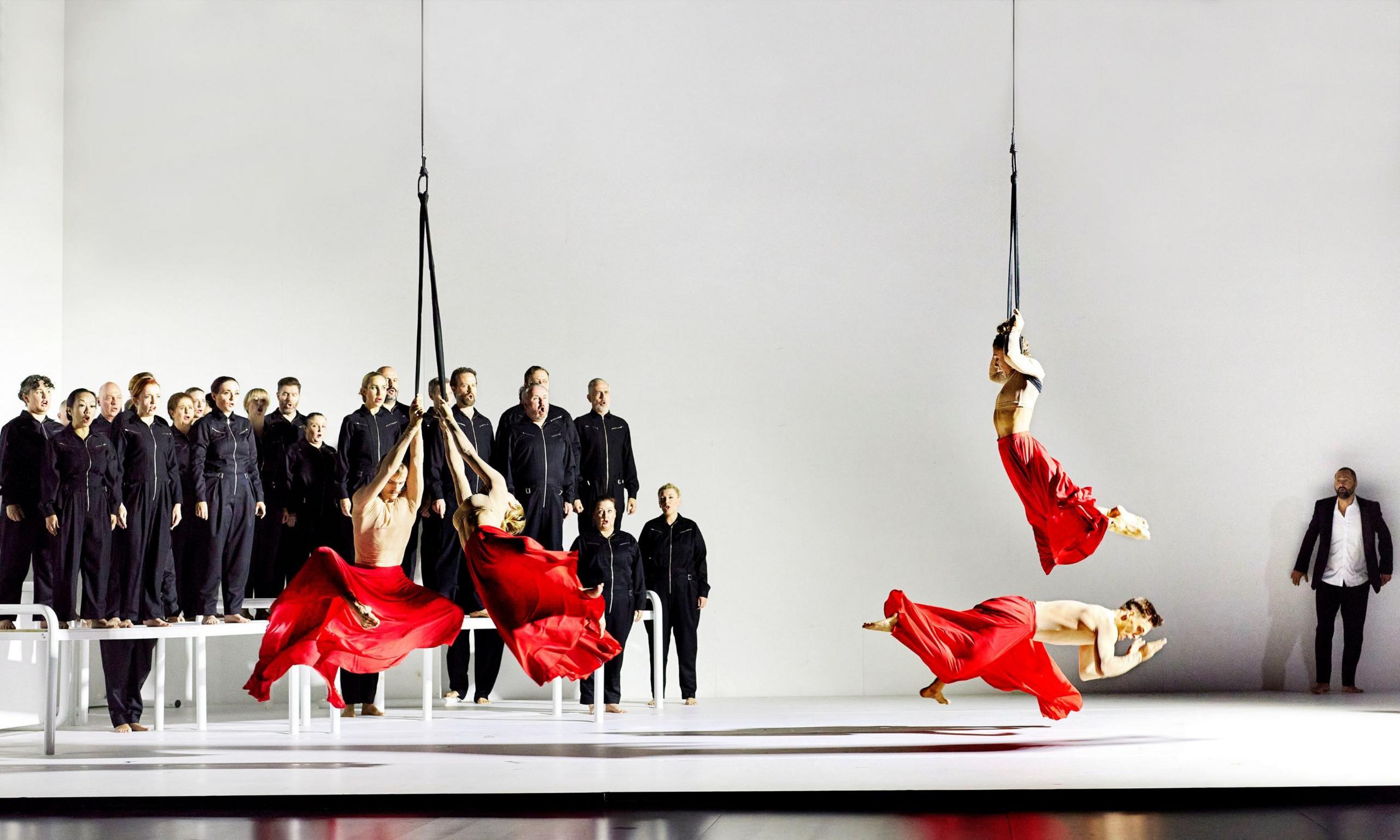 Performers rehearsing Orpheus and Eurydice by Australian Opera, featuring acrobatic artistry by circus ensemble Circa.

The chorus are in the background, all dressed in black and on a raised platform. In the foreground are four of the circus performers, hanging and climbing on ropes. 