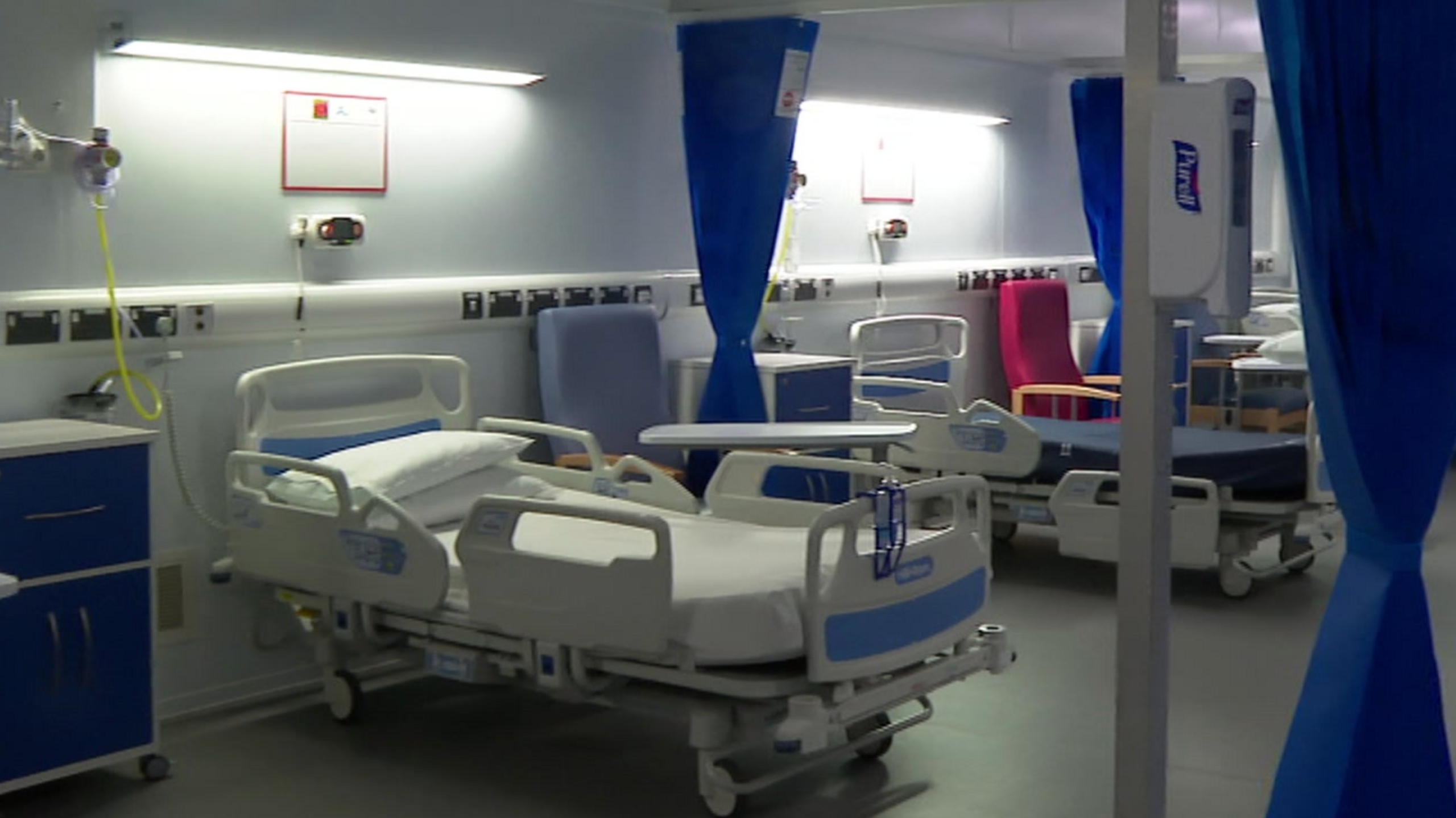 Two hospital beds with retracted bed curtains in the Buttercup unit hospital ward