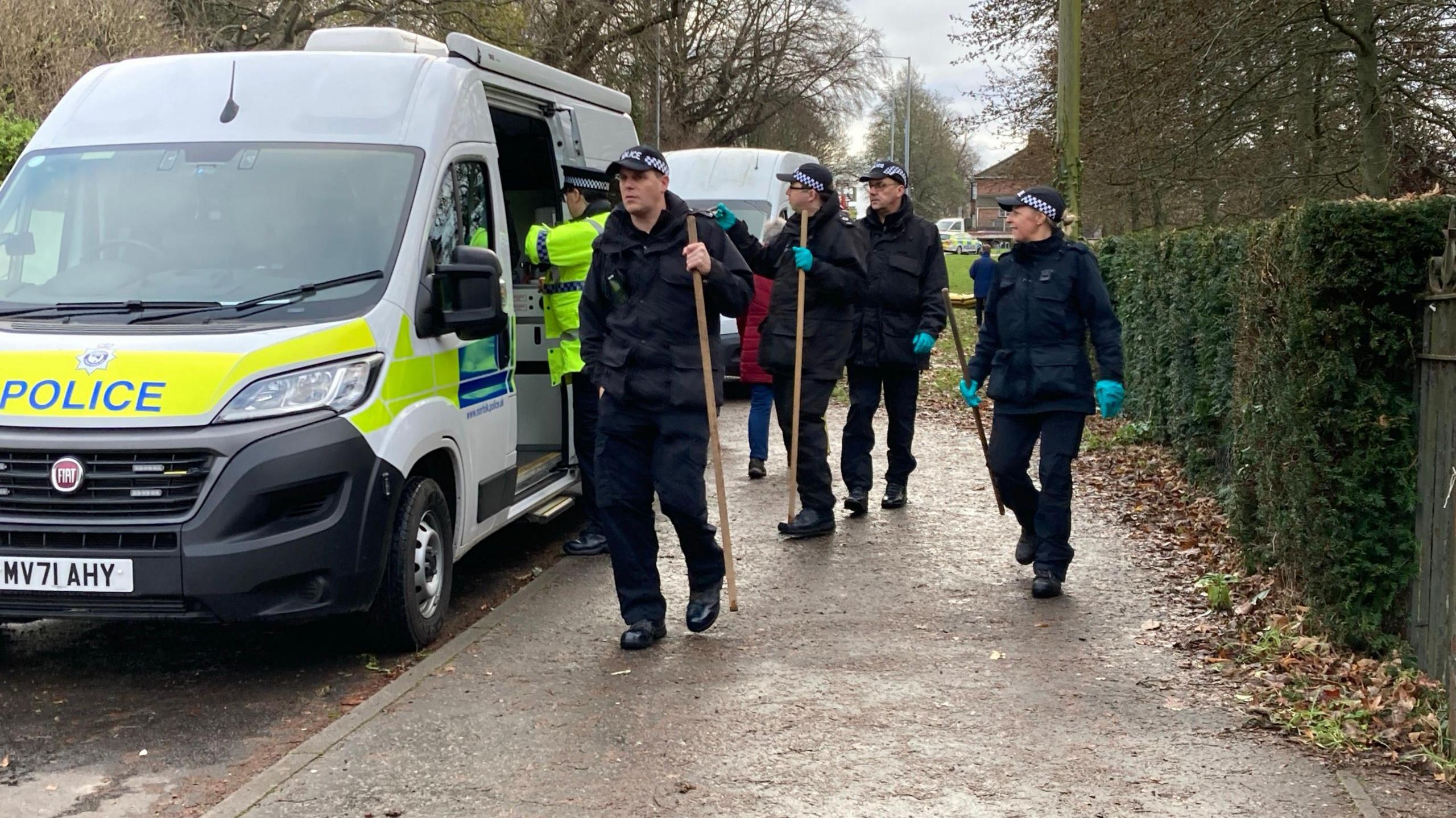 Police officers with search equipment