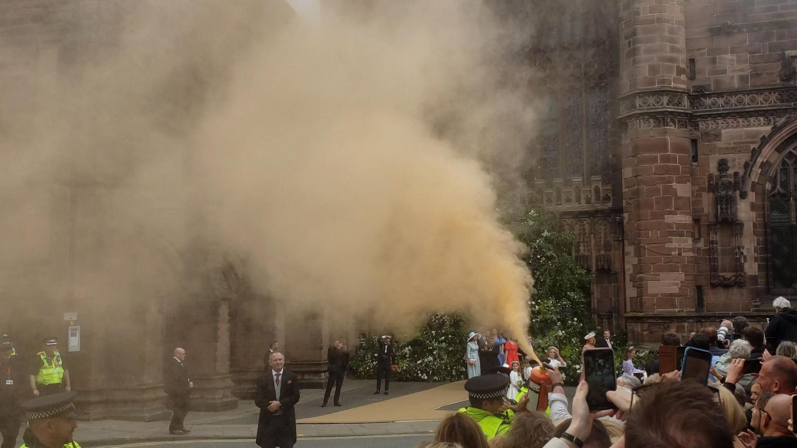 A plume of orange powder is let off