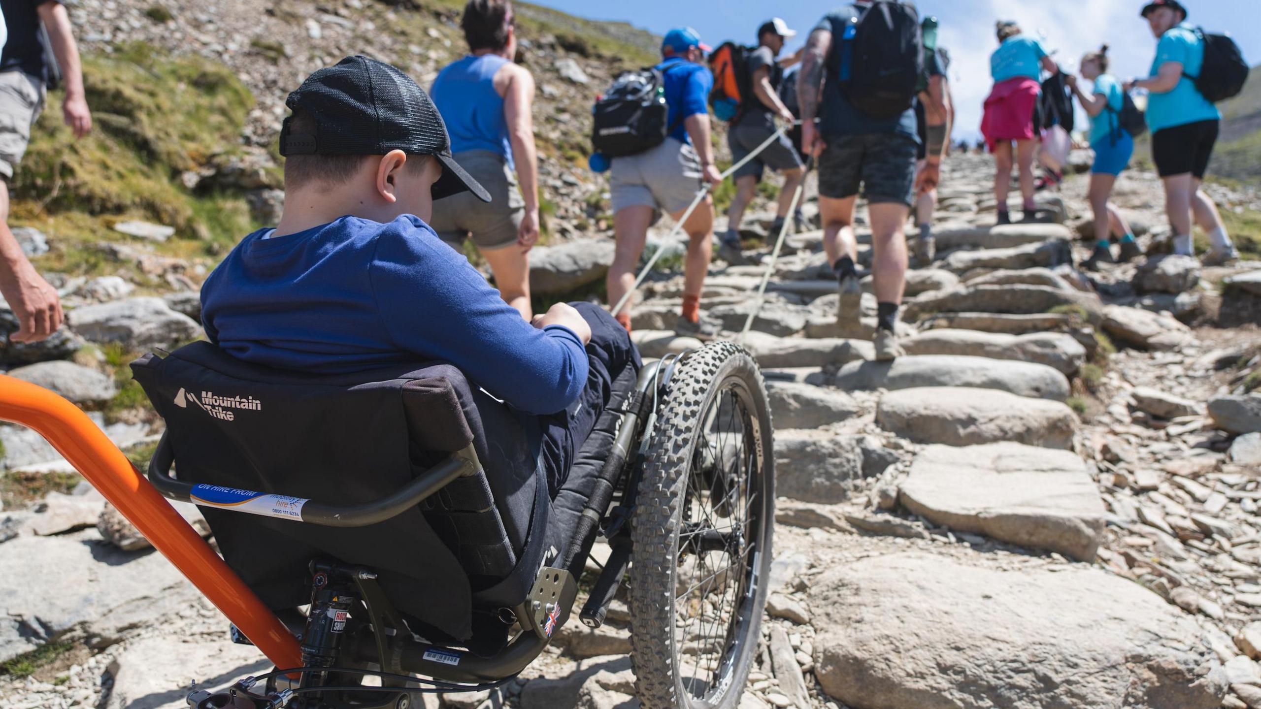 Albert's wheelchair being pulled