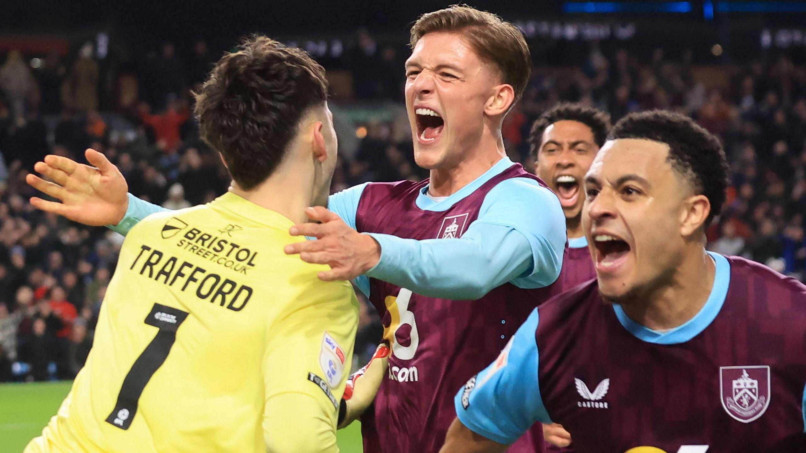 Oliver Sonne (centre) celebrates with Burnley goalkeeper James Trafford 