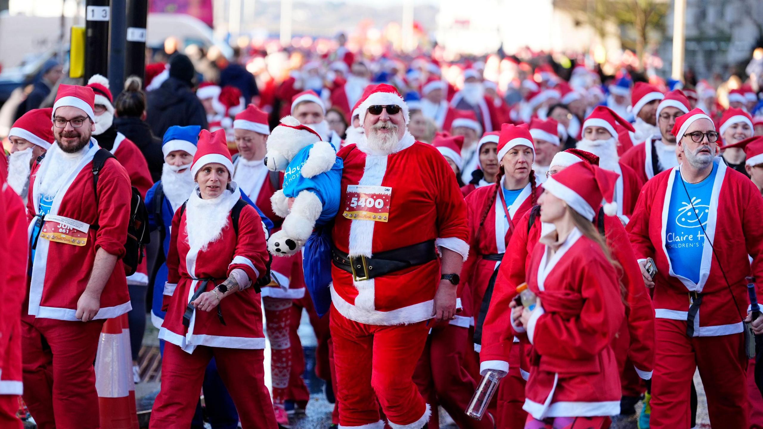 Hordes of runners dressed in Santa outfits pack the street