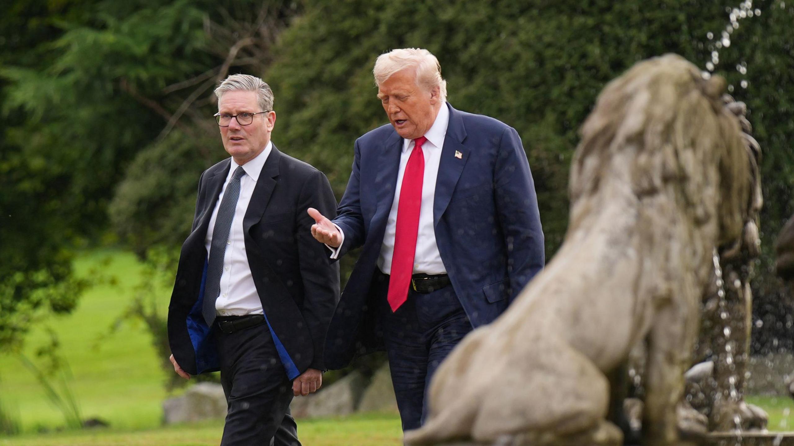 U.S. President Donald Trump and British Prime Minister Keir Starmer walk together as they arrive at Trump International Golf Links