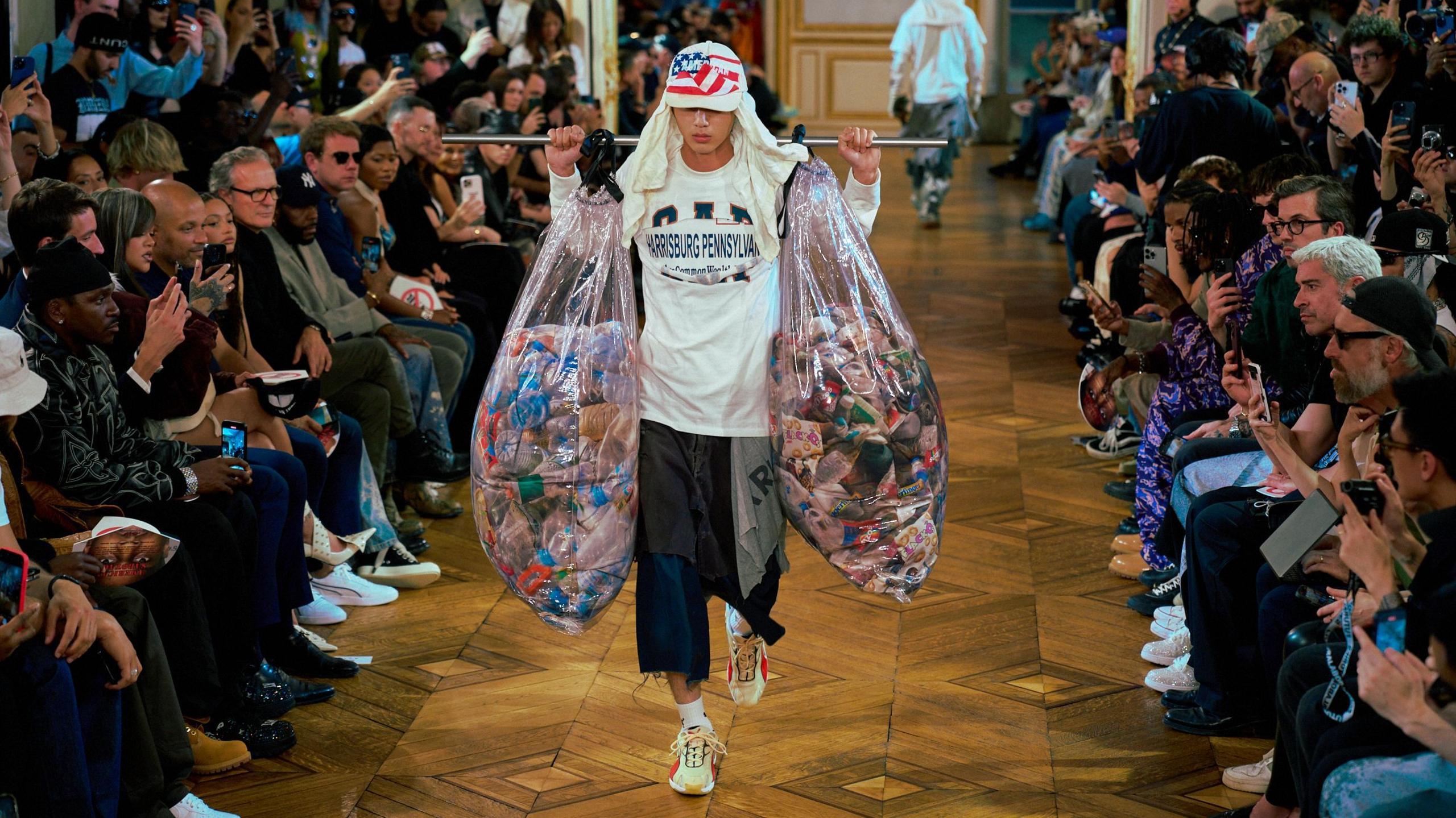 Model carries plastic bags along runway