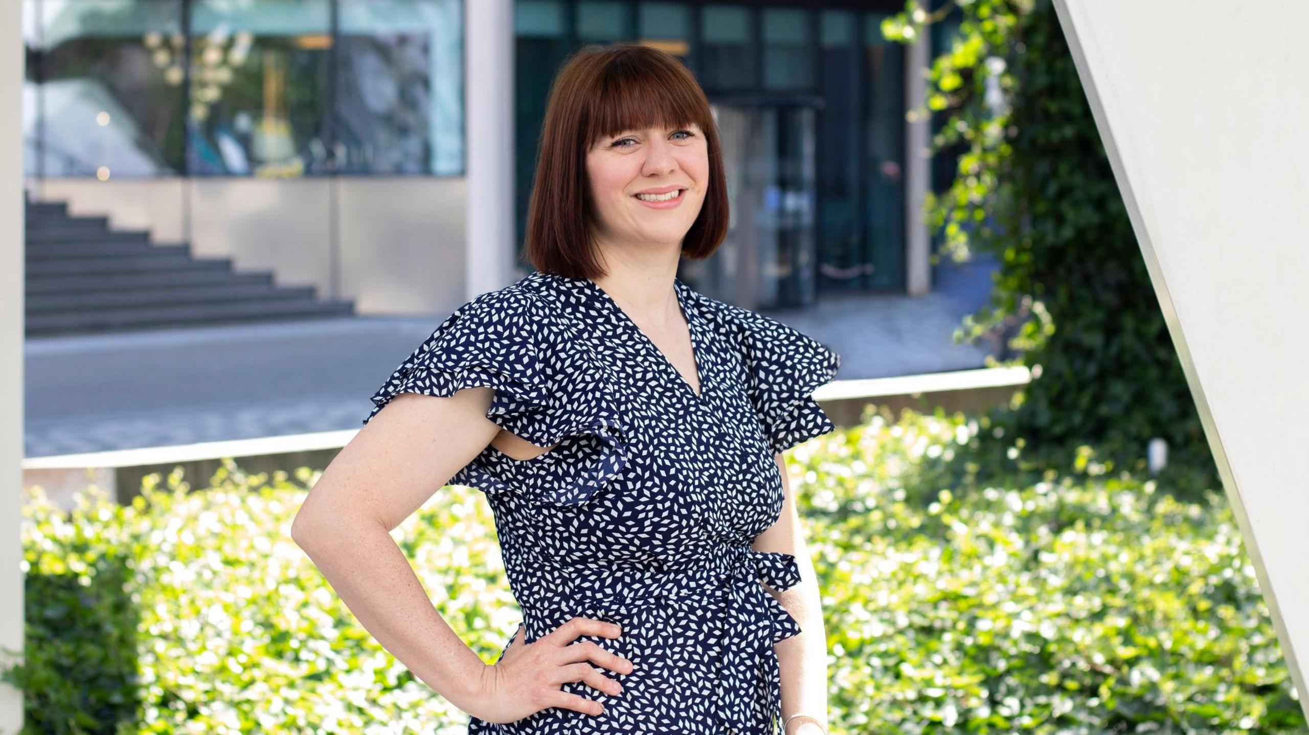 Rebecca Taylor from Secureworks, smiling wearing a summer dress