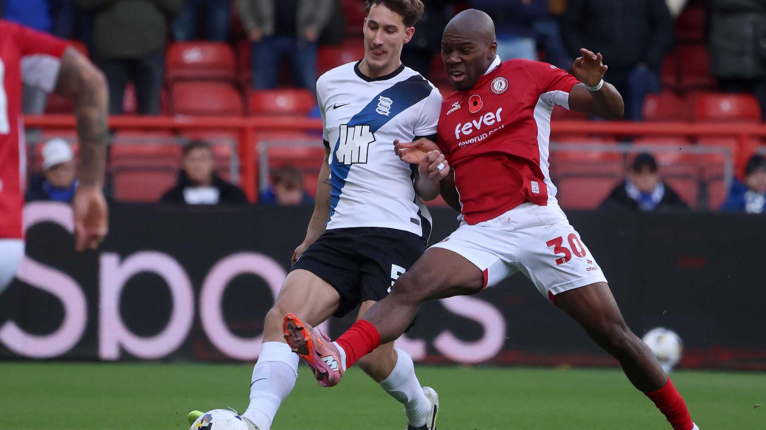 Bristol City forward Sinclair Armstrong (right) competes for the ball with Birmingham City's Phil Neumann.
