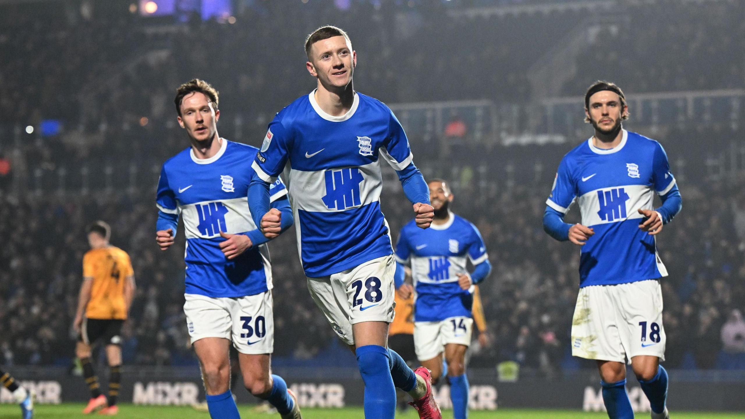 Jay Stansfield (second left) runs with his team-mates after scoring