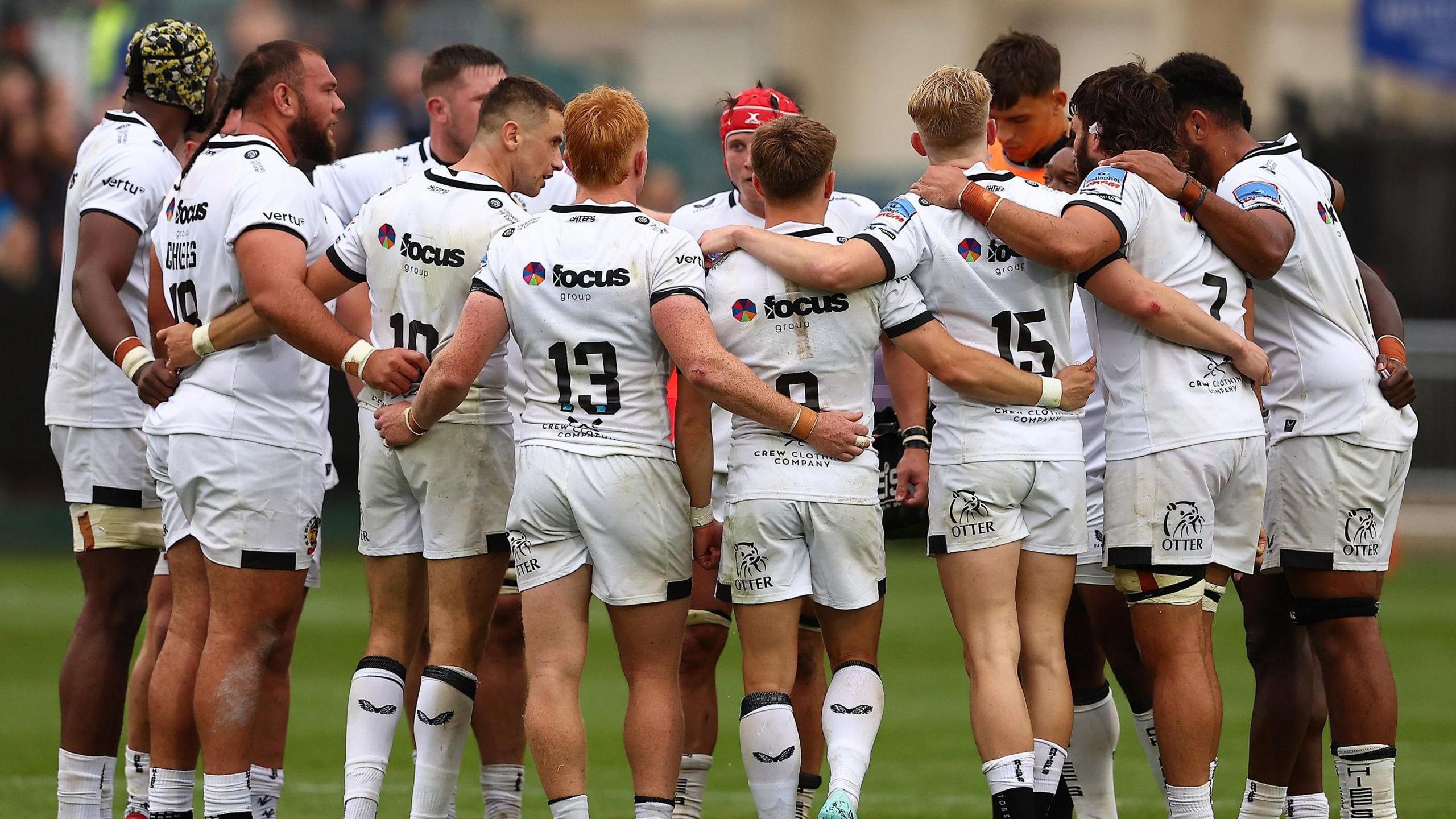 Exeter players in a huddle before the Bath Prem Rugby Cup match