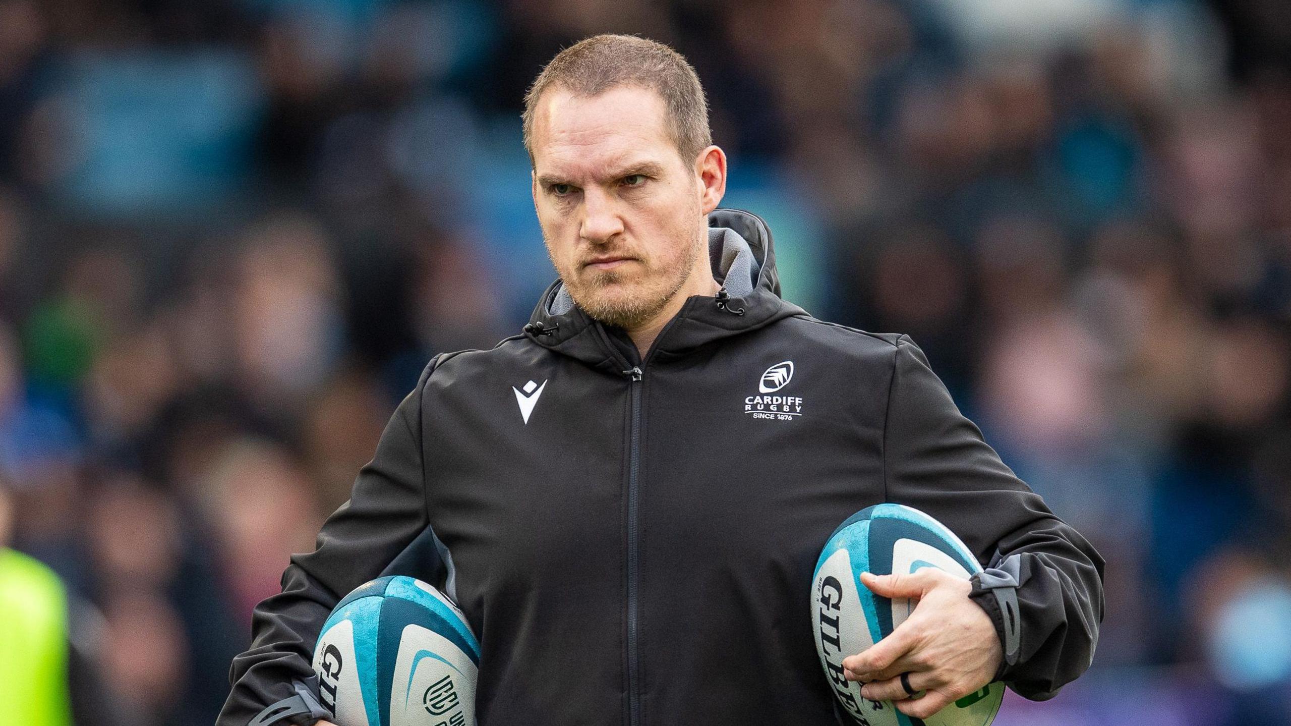 Gethin Jenkins holding rugby balls during training