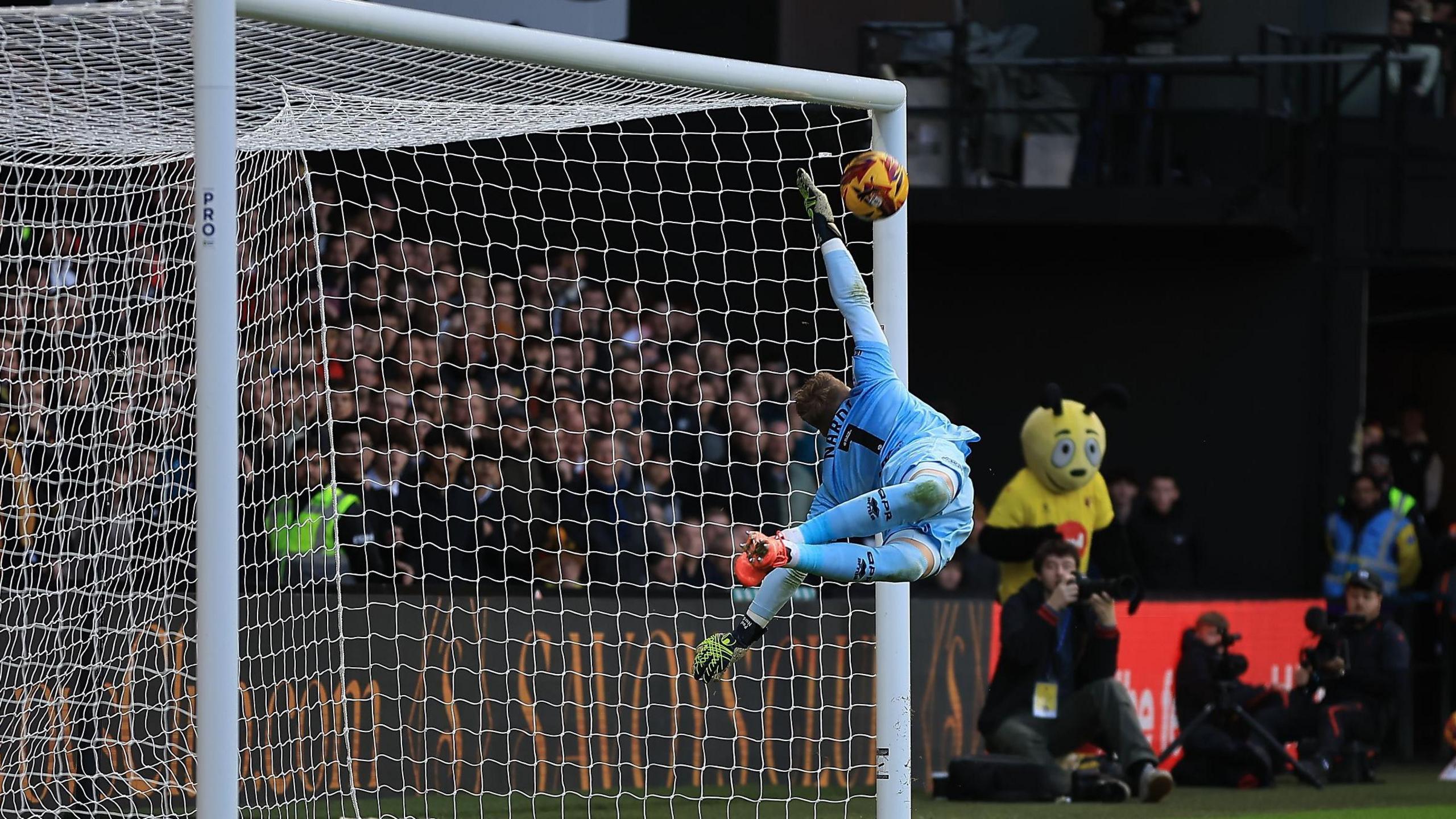 QPR goalkeeper Paul Nardi is beaten as Imran Louza's free-kick hits the bar