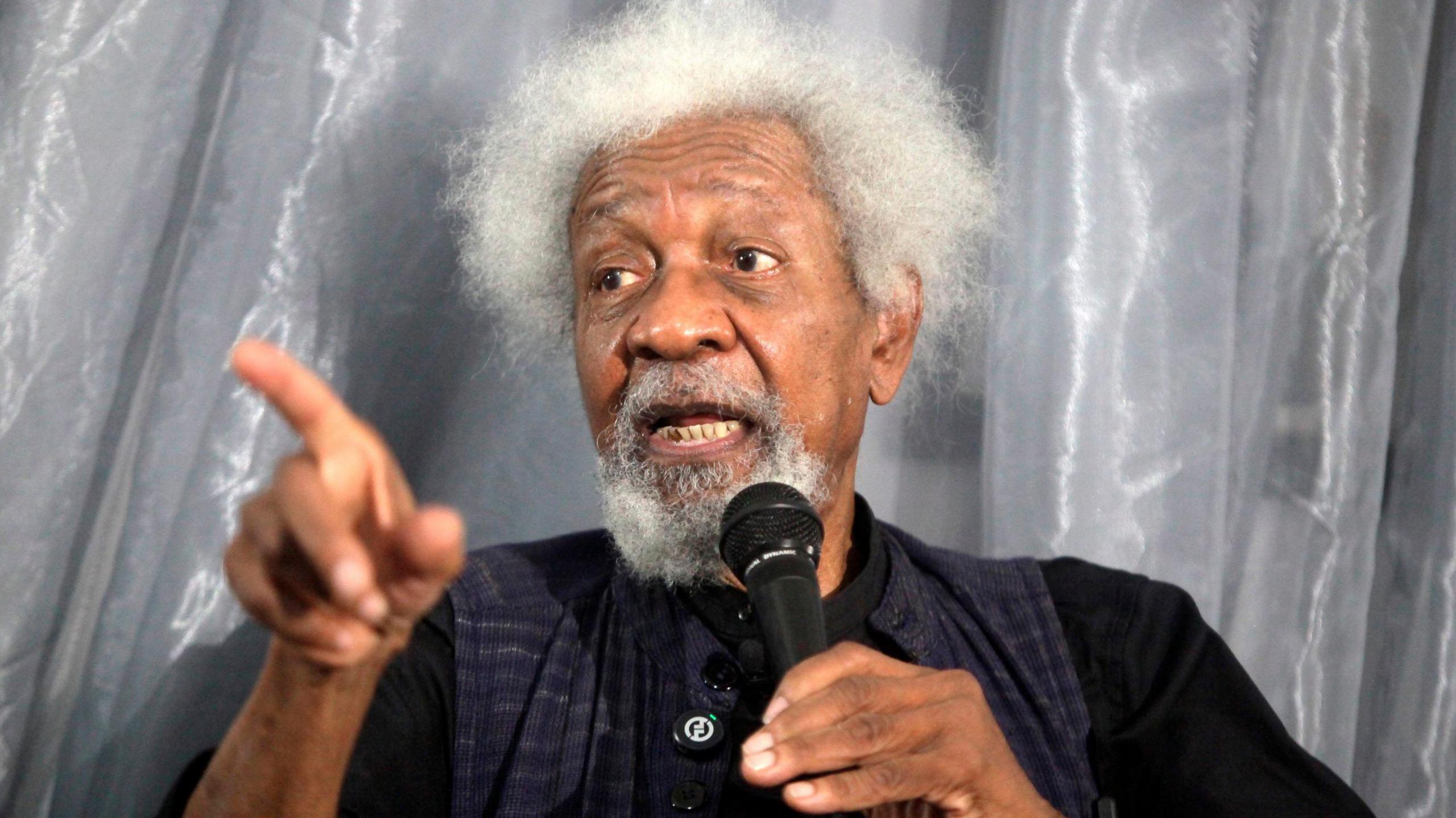 Wole Soyinka, a Nobel Laureate, gestures while speaking to a microphone