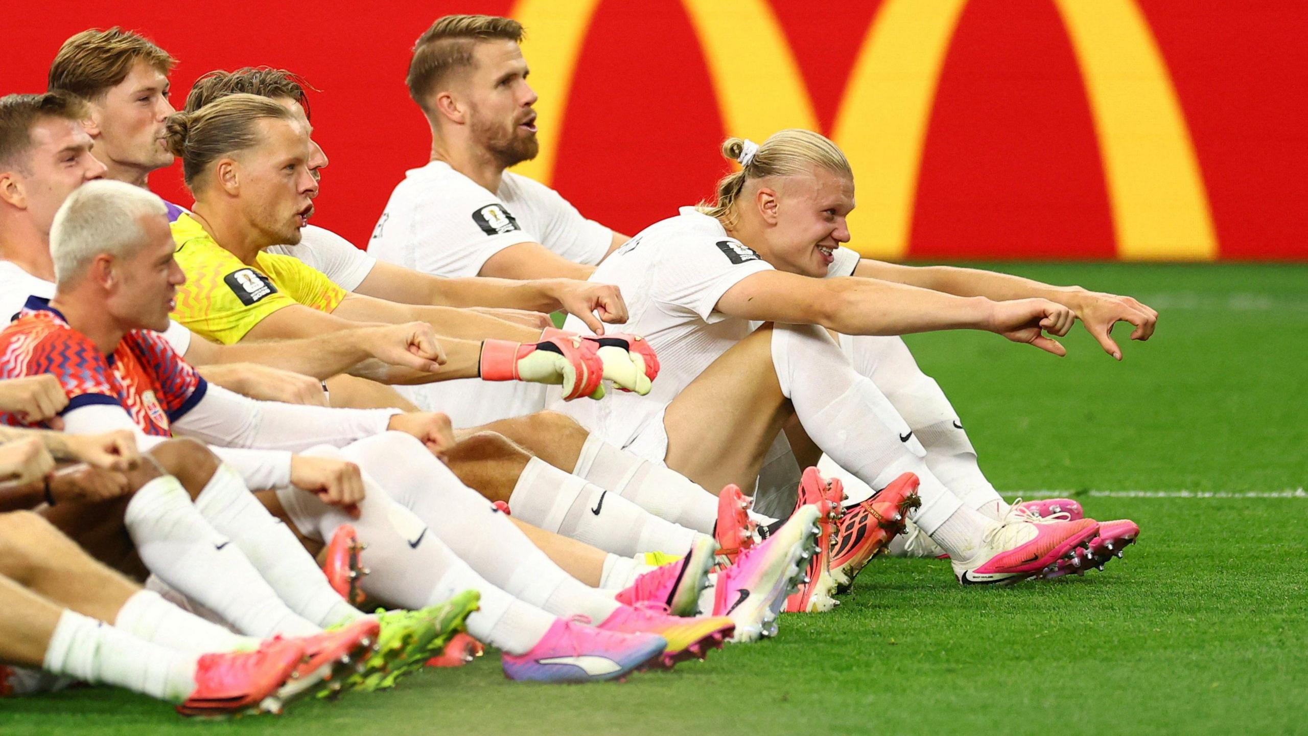 Norway's Erling Haaland celebrates with teammates as they perform the 'Viking Row' celebration after their match