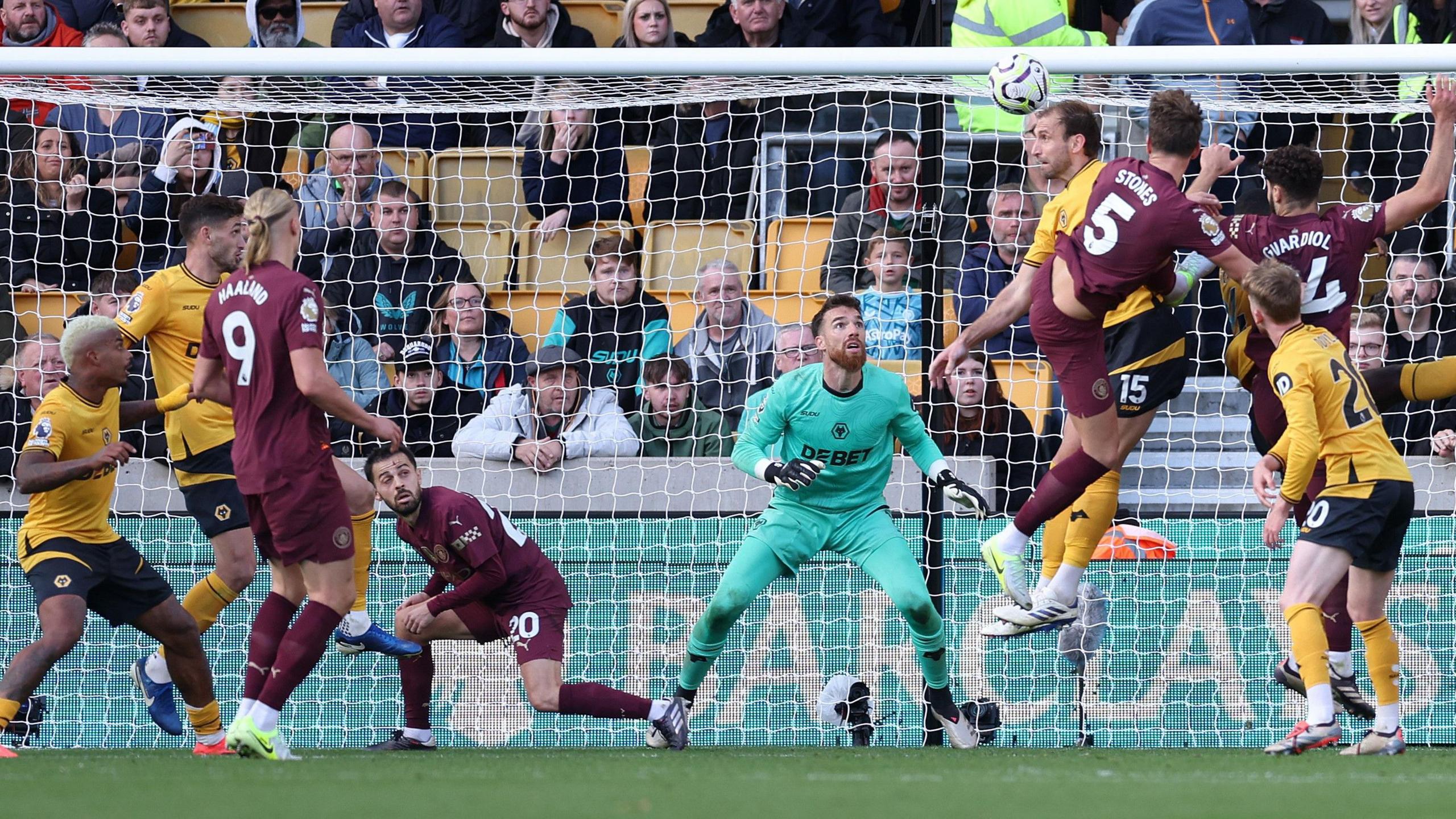 John Stones beats Craig Dawson to the ball to head in Manchester City's winner in their 2-1 victory at Wolves. 