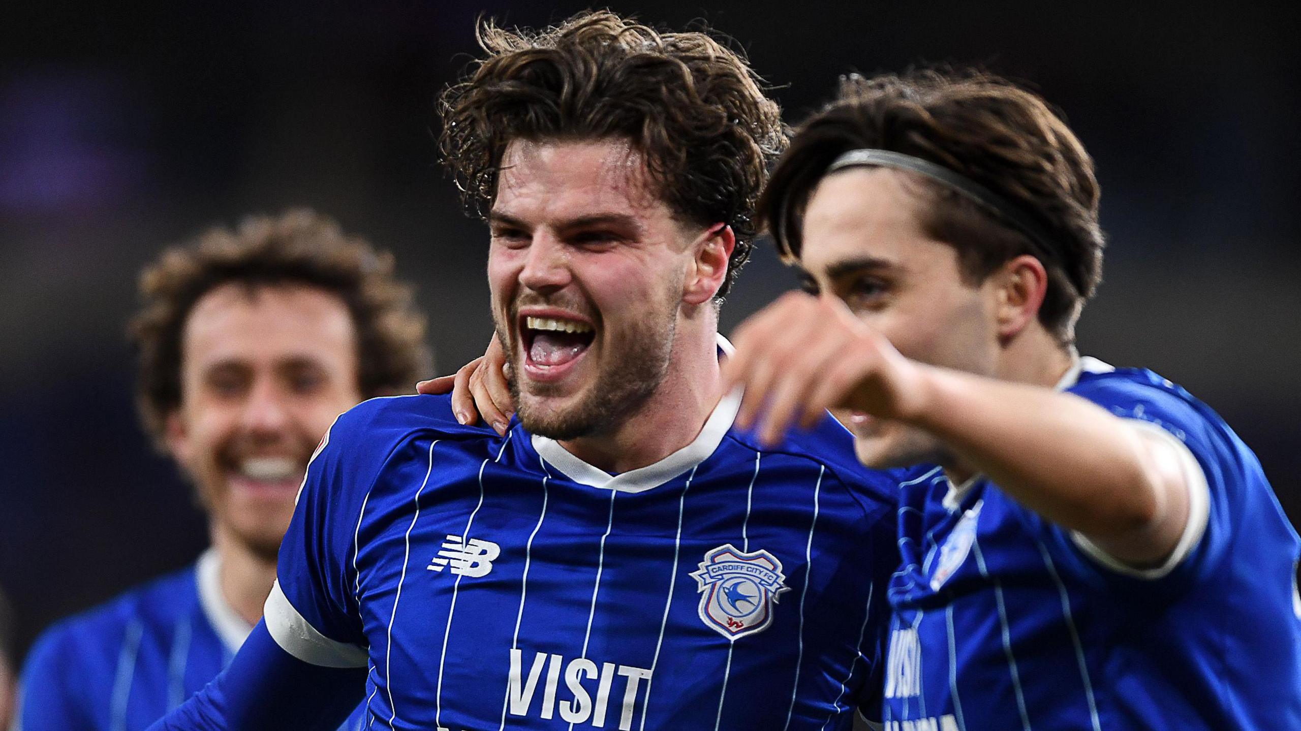 Ollie Tanner (centre) celebrates scoring for Cardiff with Joel Colwill (right)