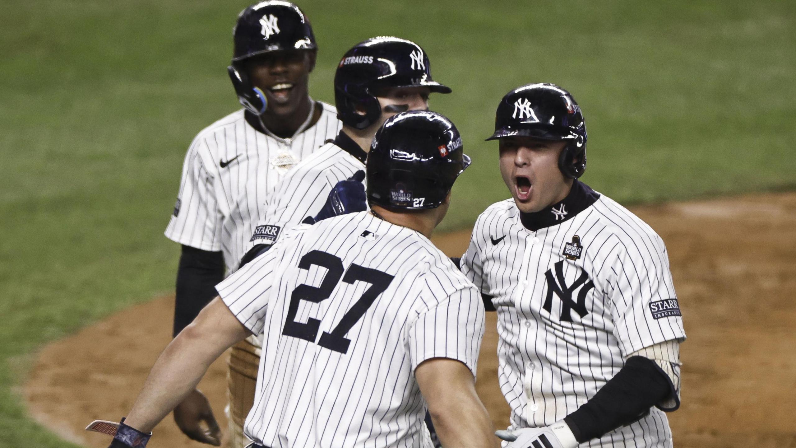 New York Yankees shortstop Anthony Volpe (right) celebrates after hitting a grand slam in game four