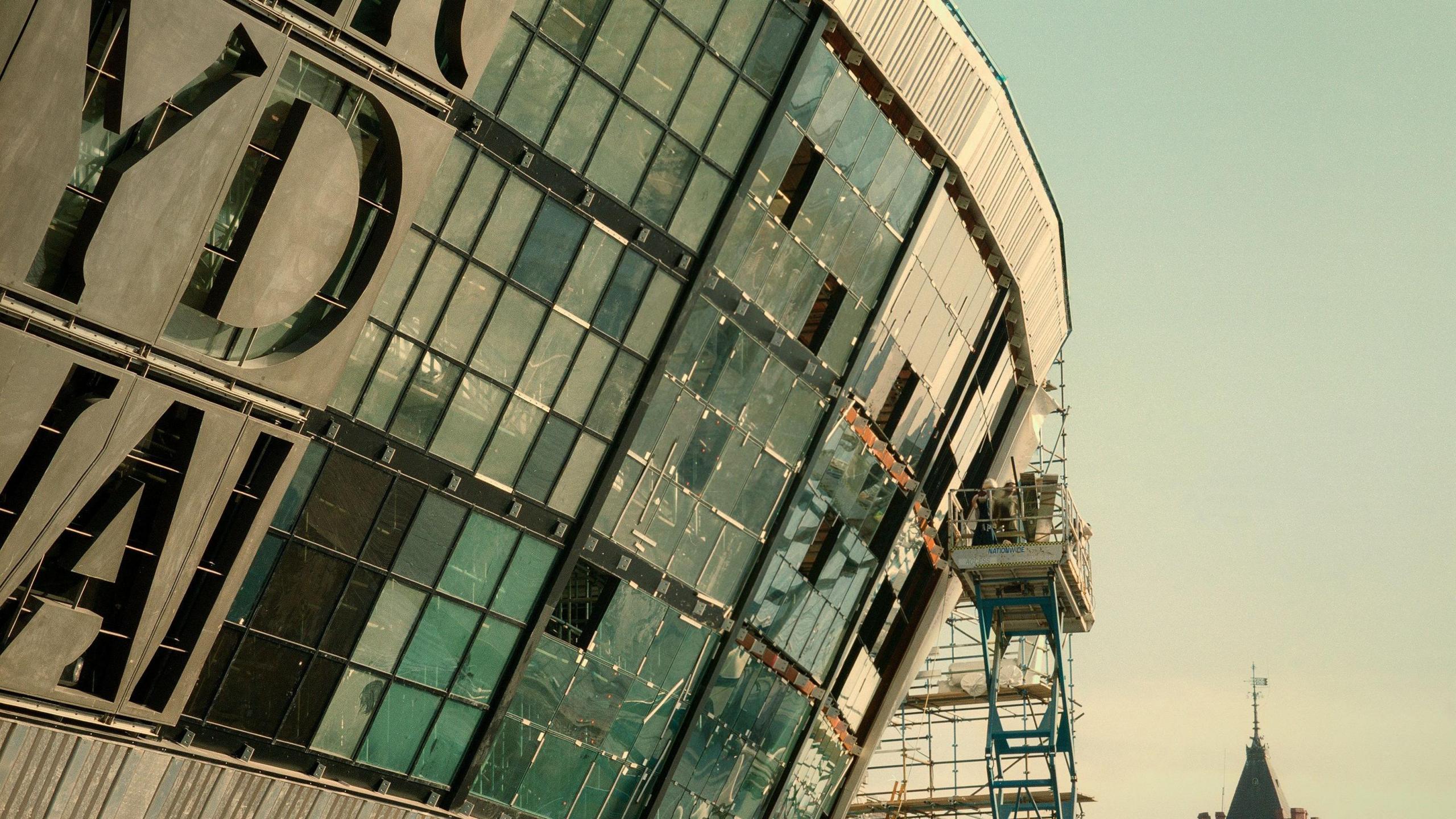 Builders assemble the iconic inscription on the side of the Wales Millennium Centre.