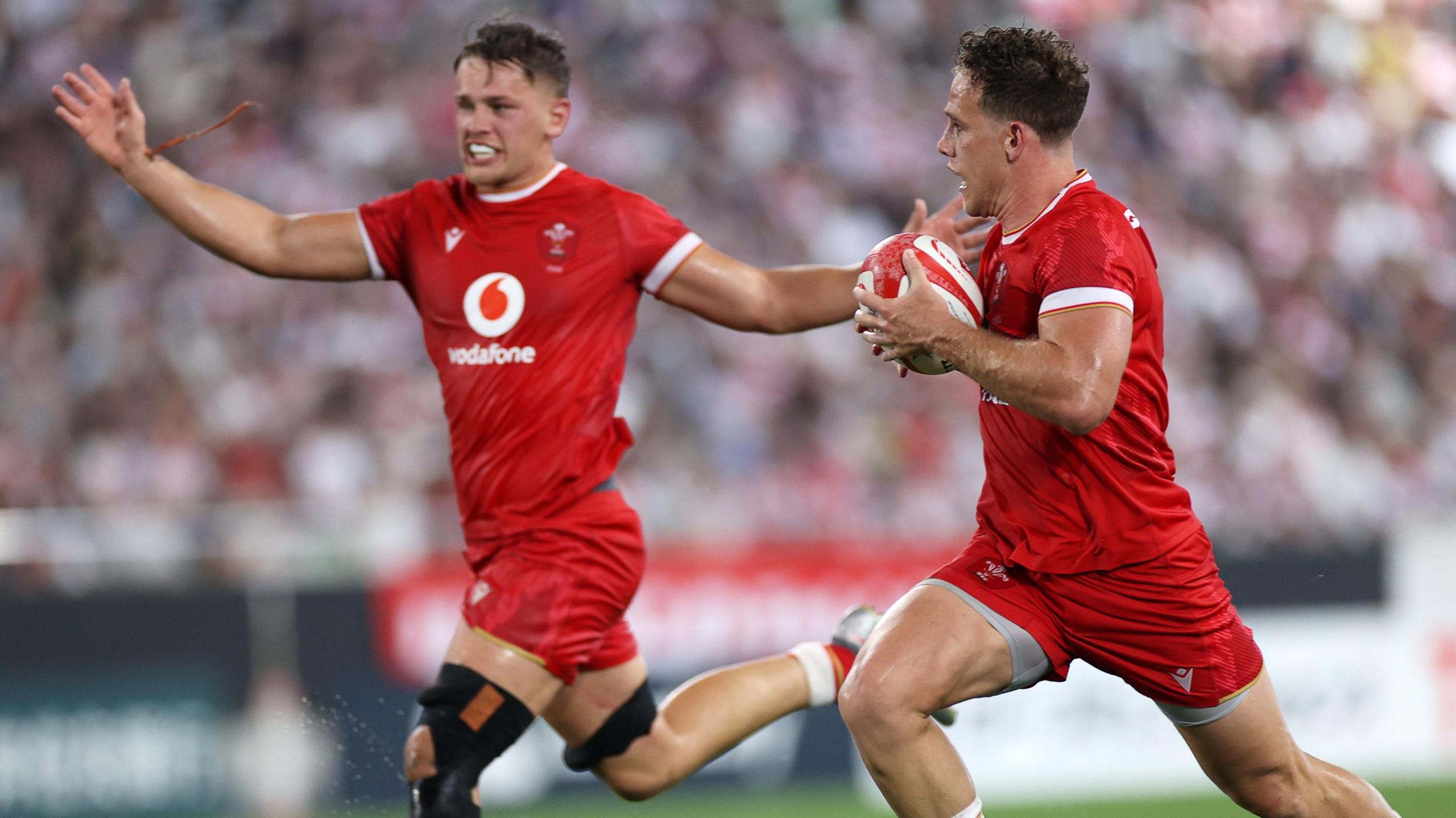 Alex Mann celebrates a try scored by Wales scrum-half Kieran Hardy