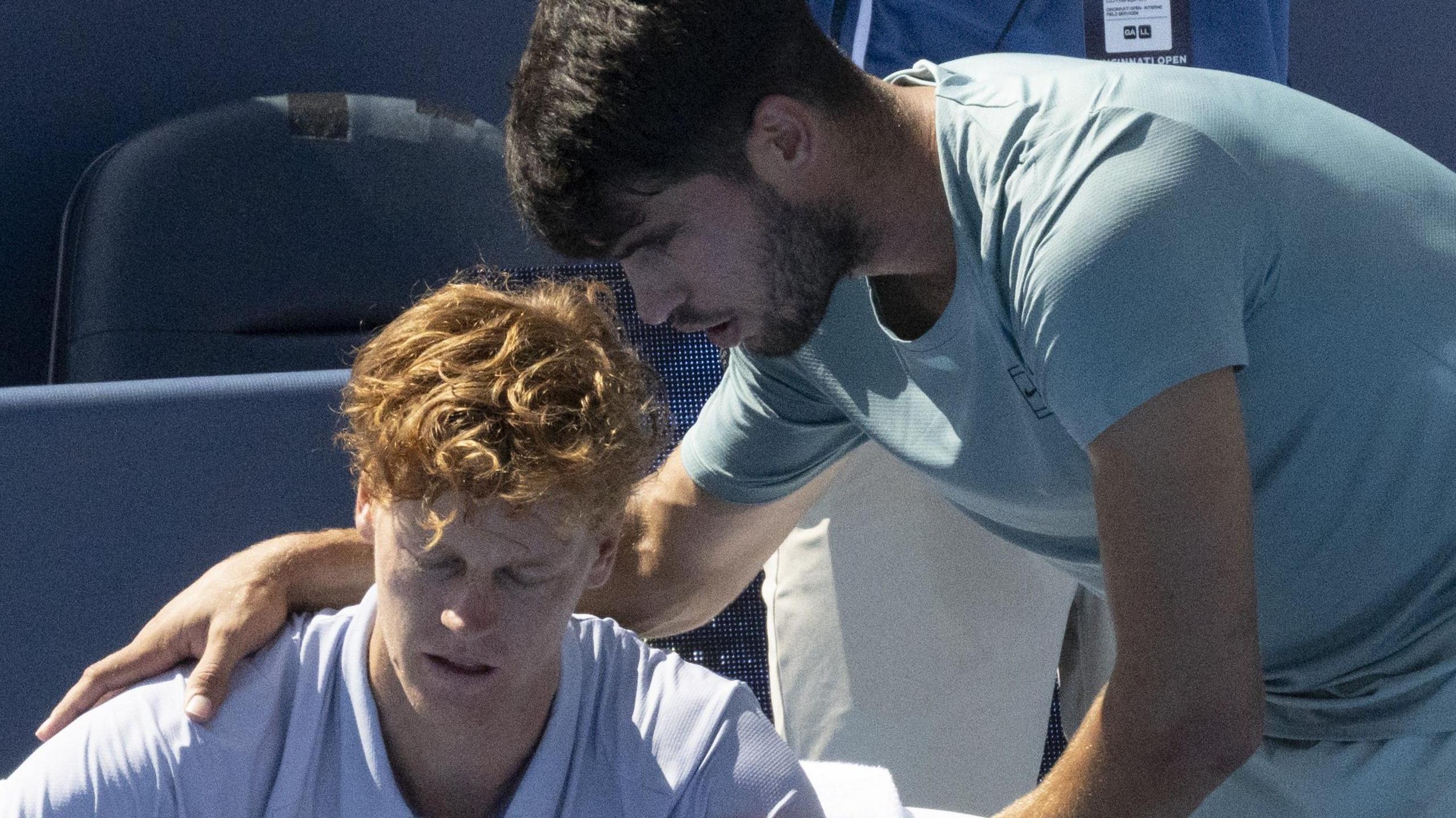 Jannik Sinner is consoled by Carlos Alcaraz at the Cincinnati Open