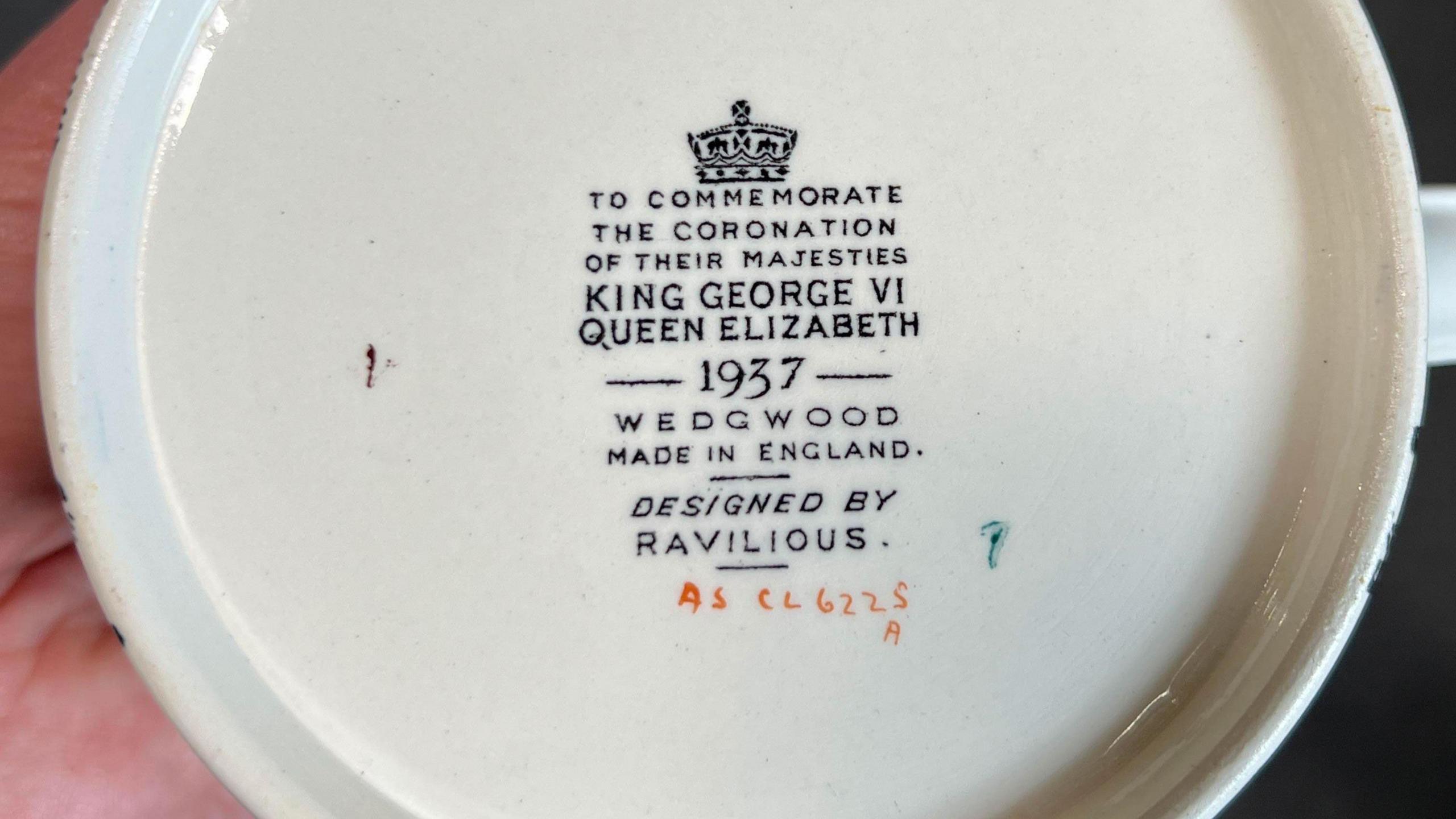 The bottom of a rare Wedgwood coronation mug in yellow