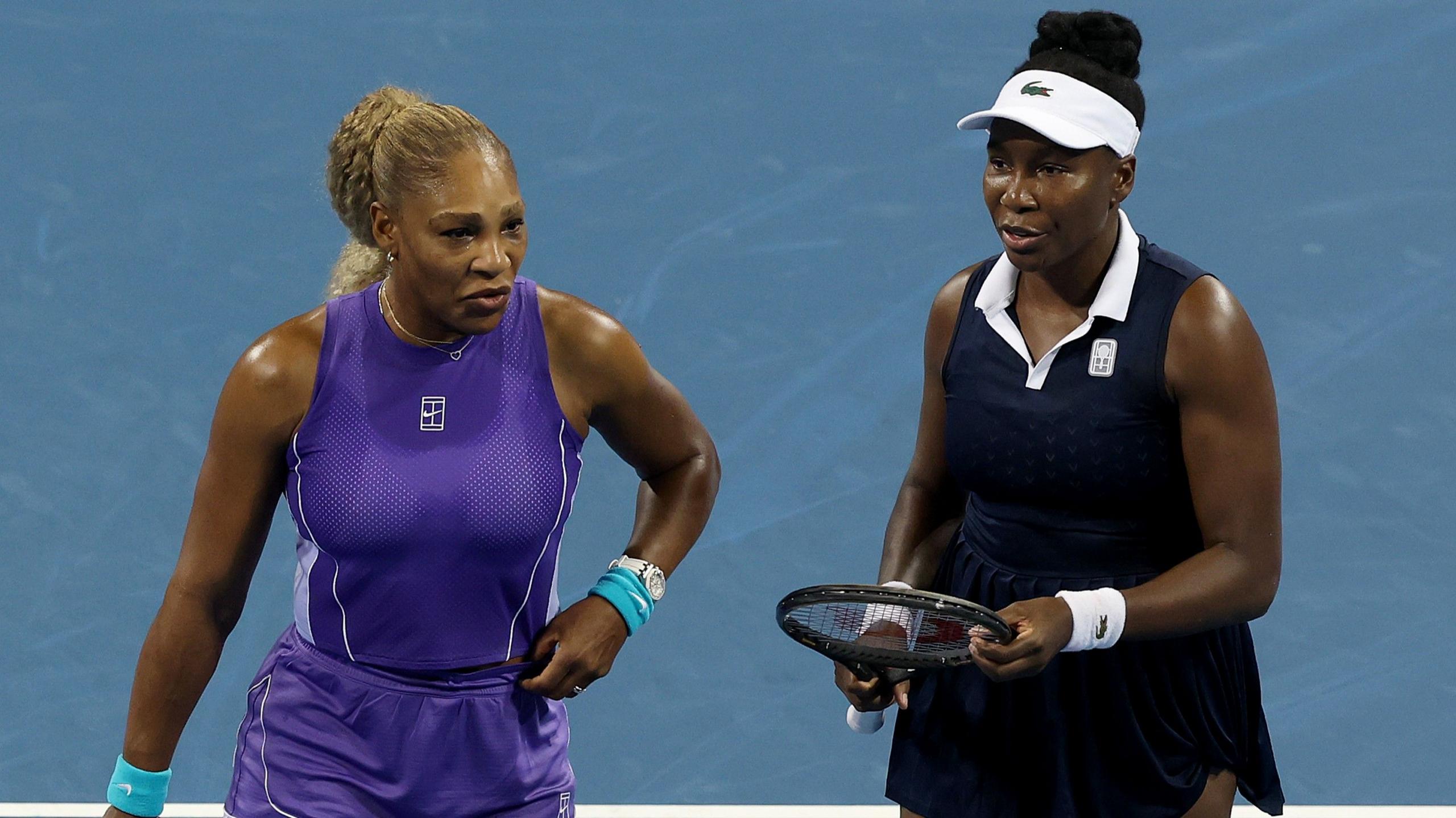 Serena Williams speaks to Venus Williams during their doubles match at the Cincinnati Open
