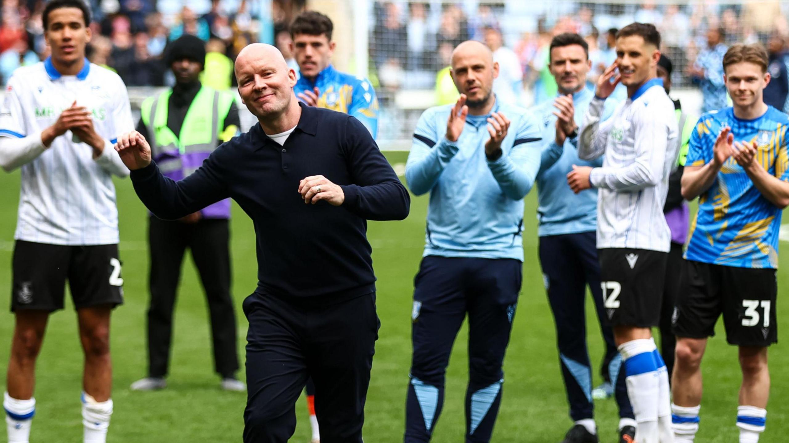 Henrik Pedersen celebrates Sheffield Wednesday's fine draw at champions-elect Coventry on the pitch with his players.