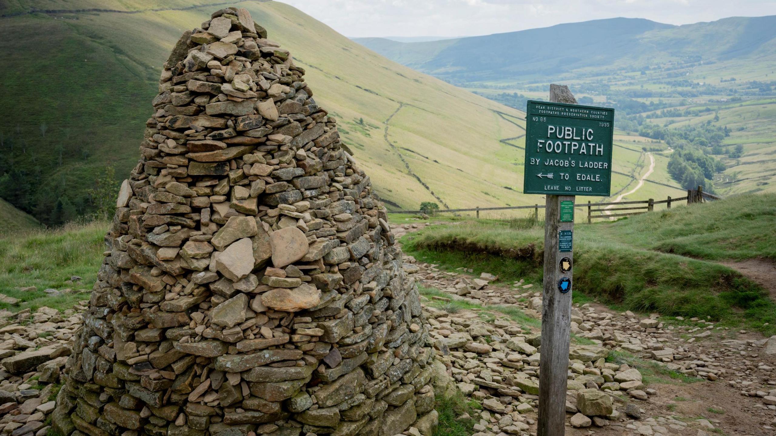 The cairn at the top of Jacob's ladder steps en-route to Kinder Scout on the lower stages of the Pennine Way, on 17th July 2024, in Edale, Derbyshire.