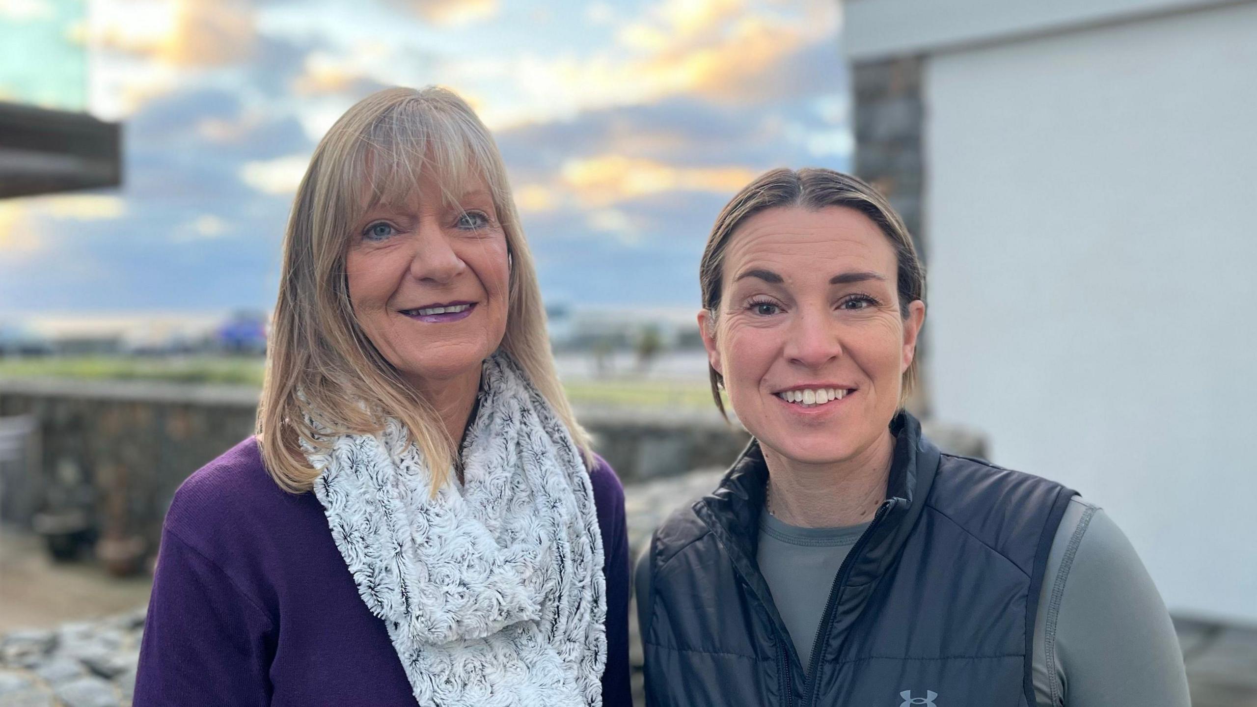 Andrea Nightingale and Maddy Diligent. Andrea has blonde hair and is wearing a purple top and white scarf. Maddy has brown hair tied back and is wearing a gillet over a grey top. 