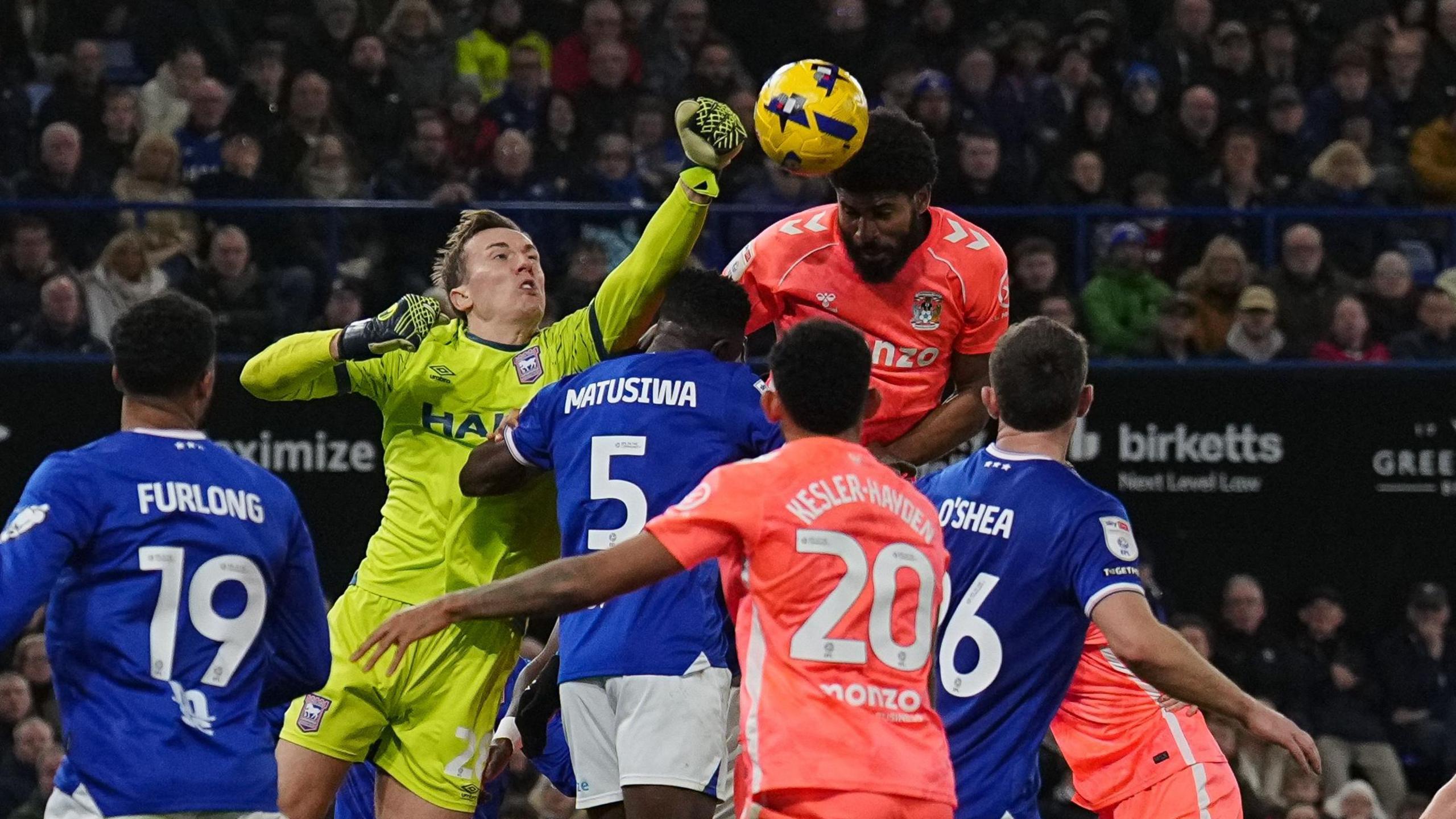 Christian Walton punches a cross clear under pressure from Coventry's Ellis Simms
