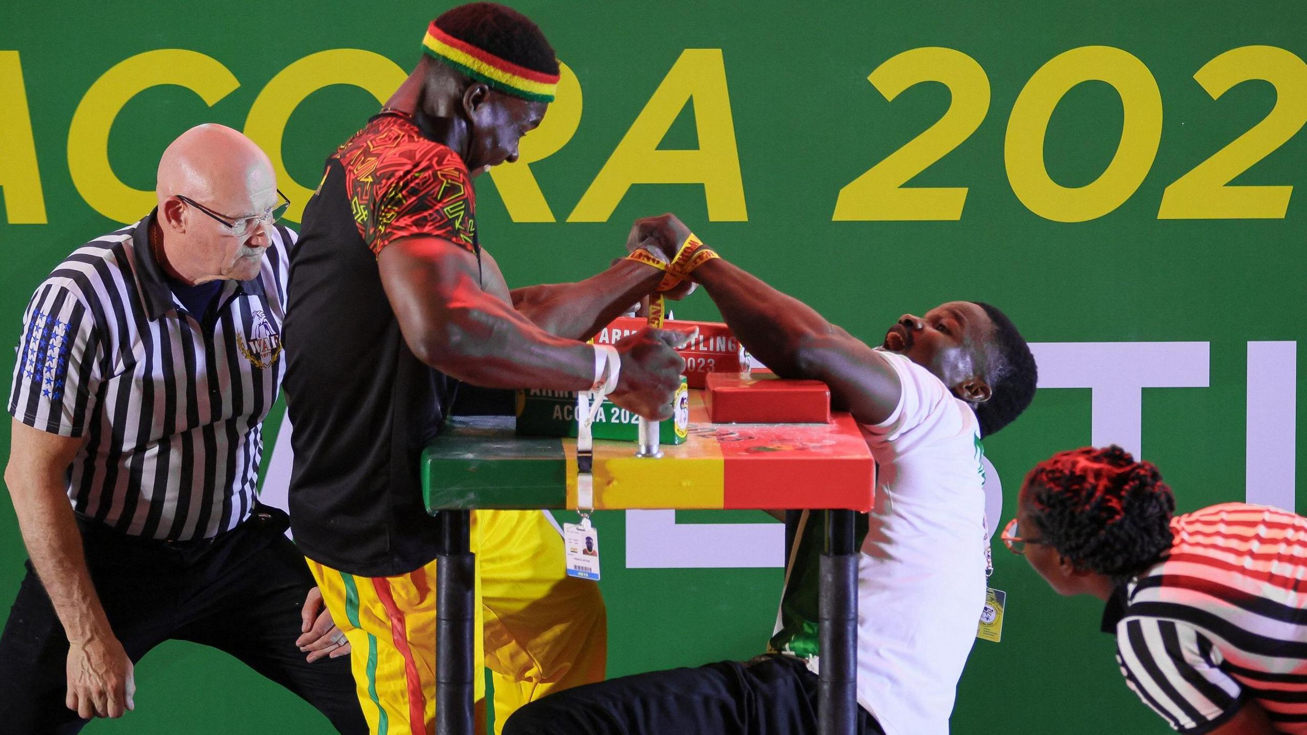 Ghana's Prince Affum (left) competes against Nigeria's Samual Nneka (right) in the Senior Men's 85 KG left arm wrestling competition during the 2023 African Games in Accra, Ghana.