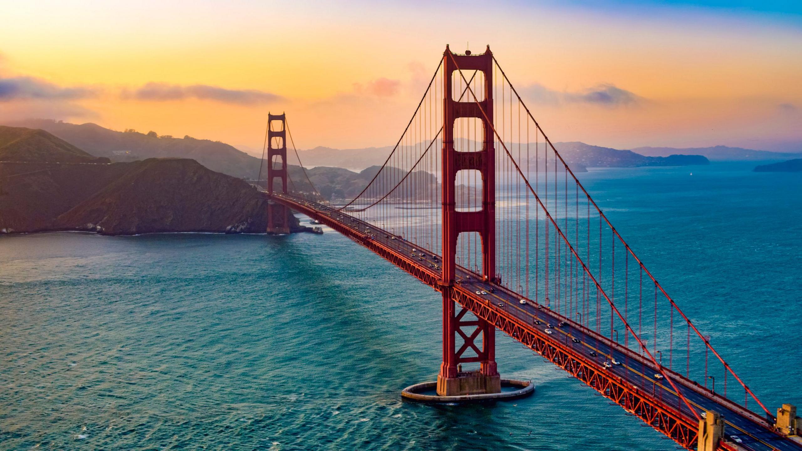 Aerial view of traffic moving on Golden Gate Bridge during sunset, San Francisco, California, USA.