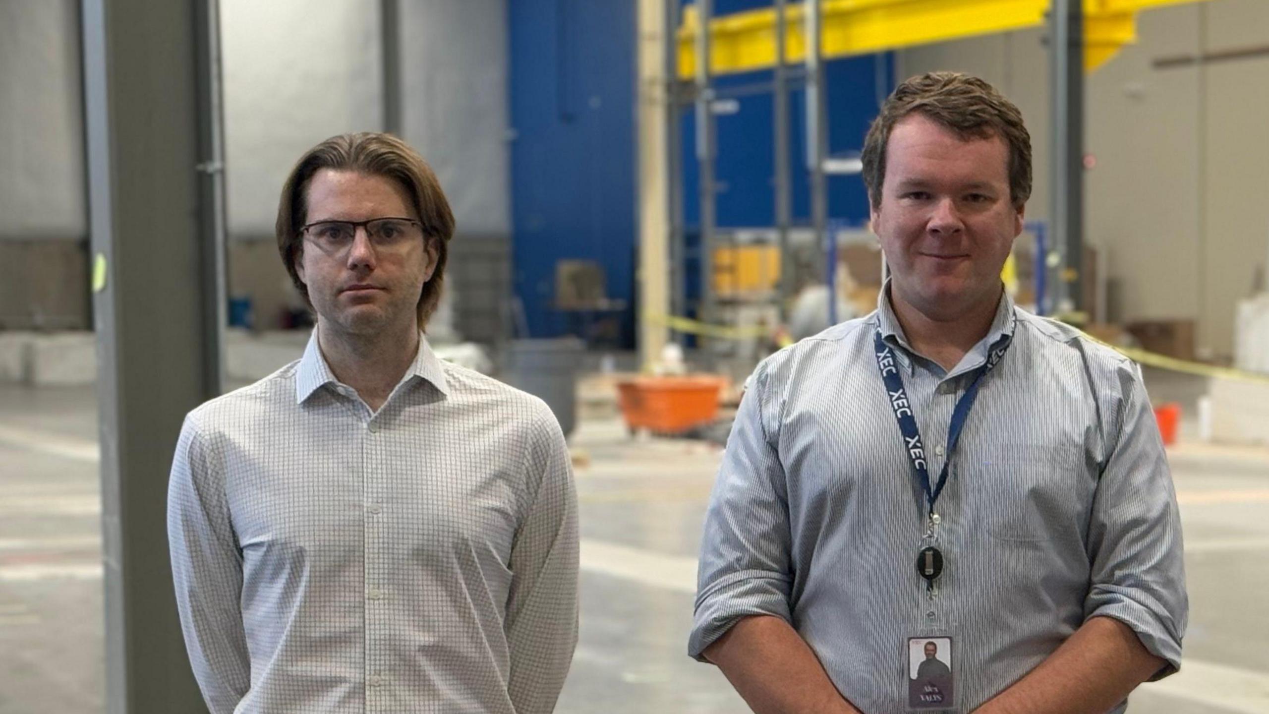 Conner Galloway (left) and Alexander Valys stading in the big empty factory which will one day house their laser-based fusion project.