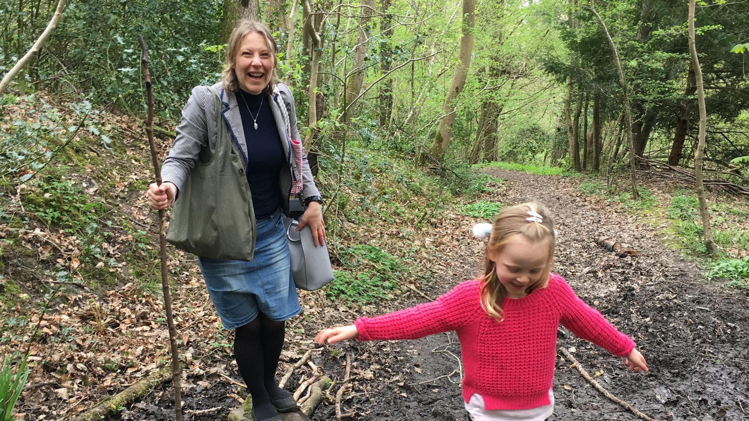 Alison Clark and her daughter Emily playing in a forest. They both look happy.