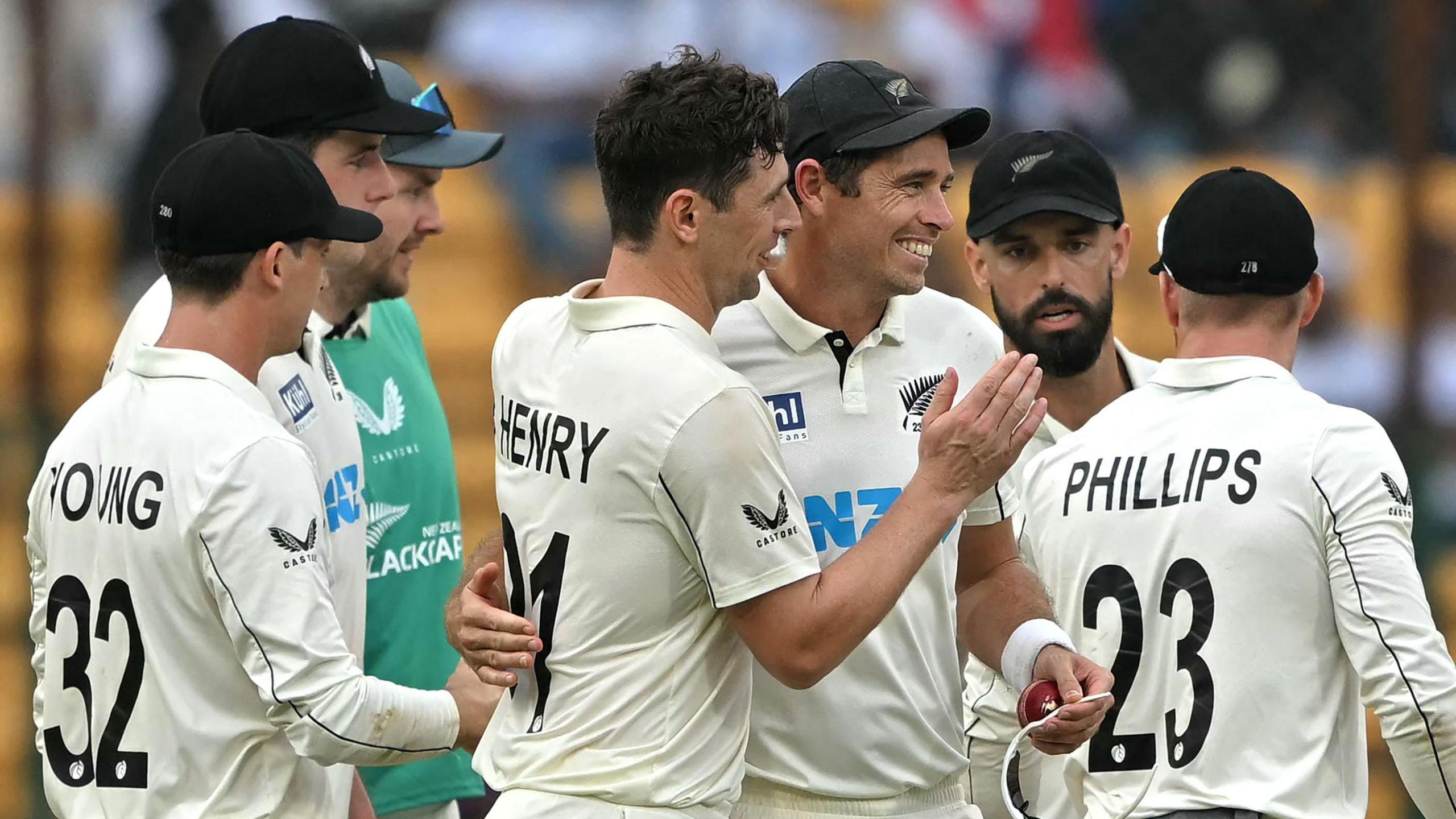 Matt Henry and Tim Southee of New Zealand celebrate a wicket against India