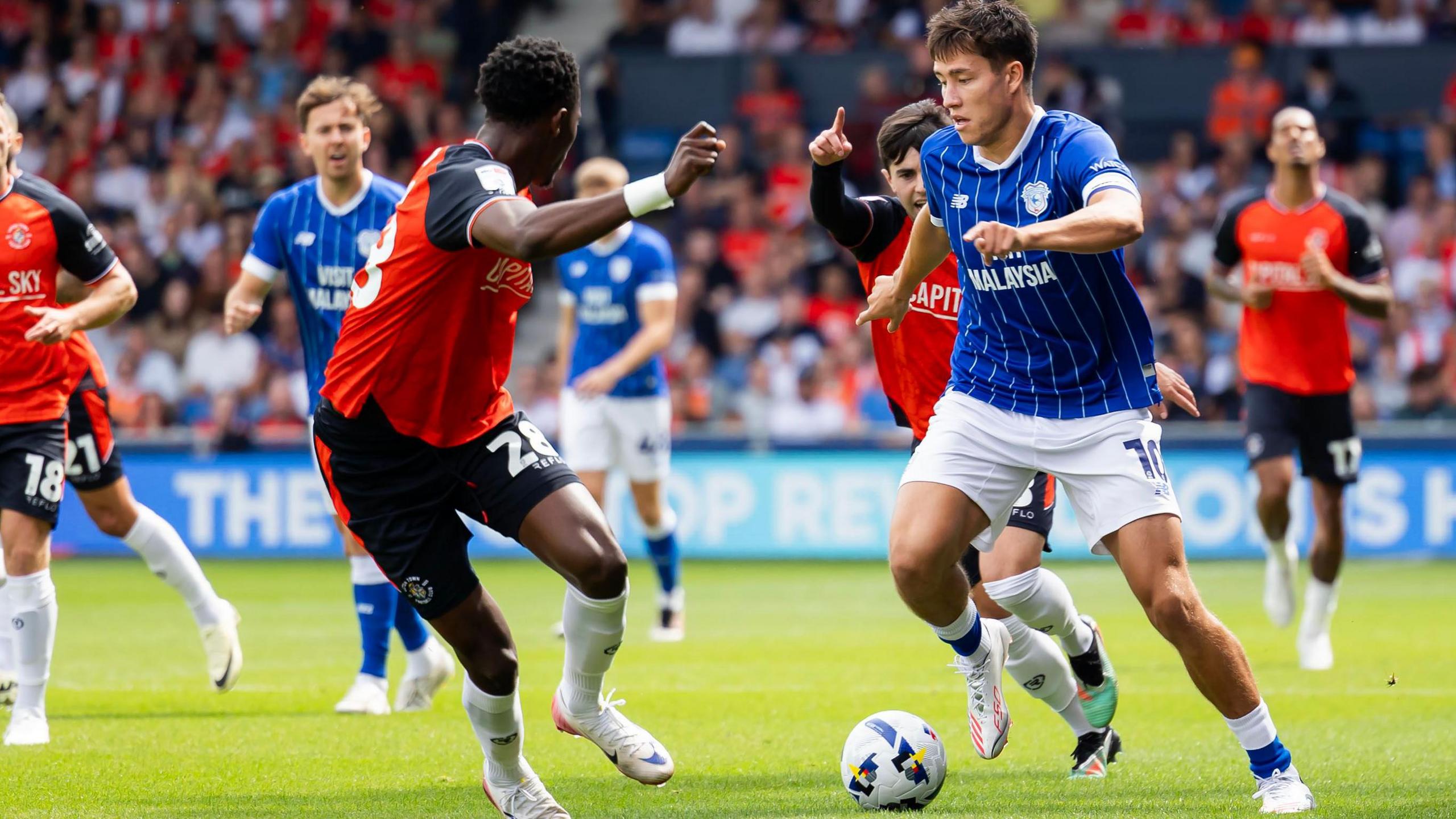 Cardiff City's Rubin Colwill (right) takes on Luton's Christ Makosso