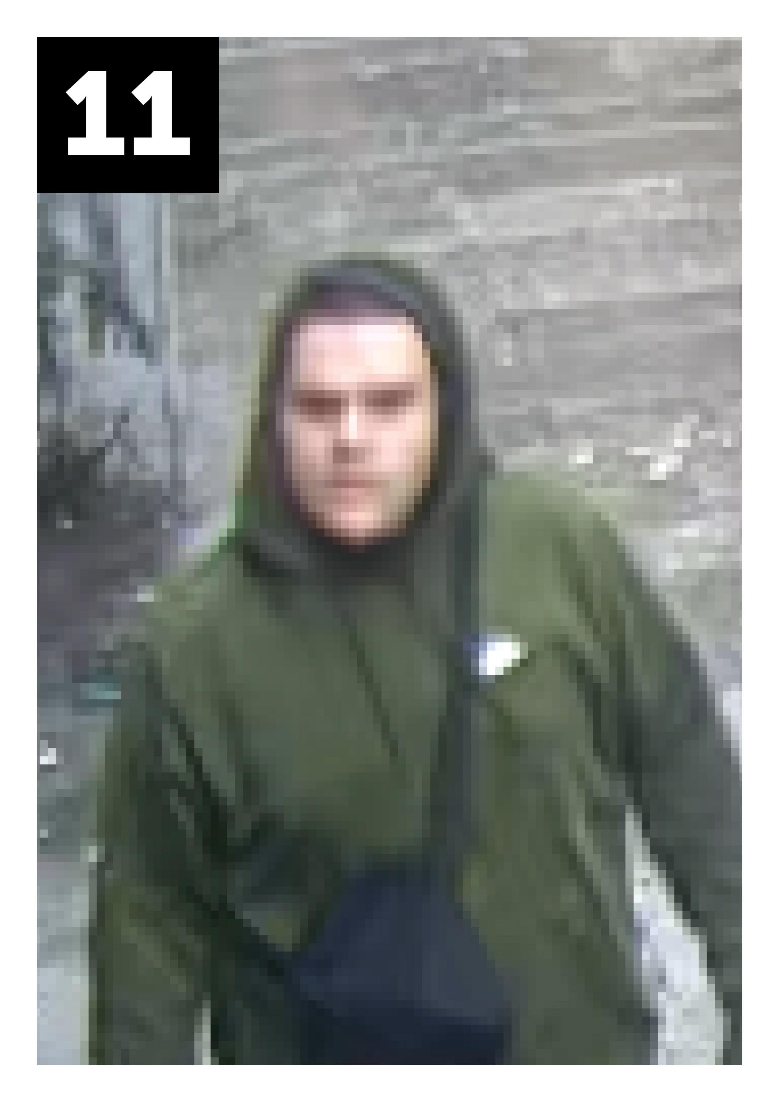 Dark haired man in green top with hood up